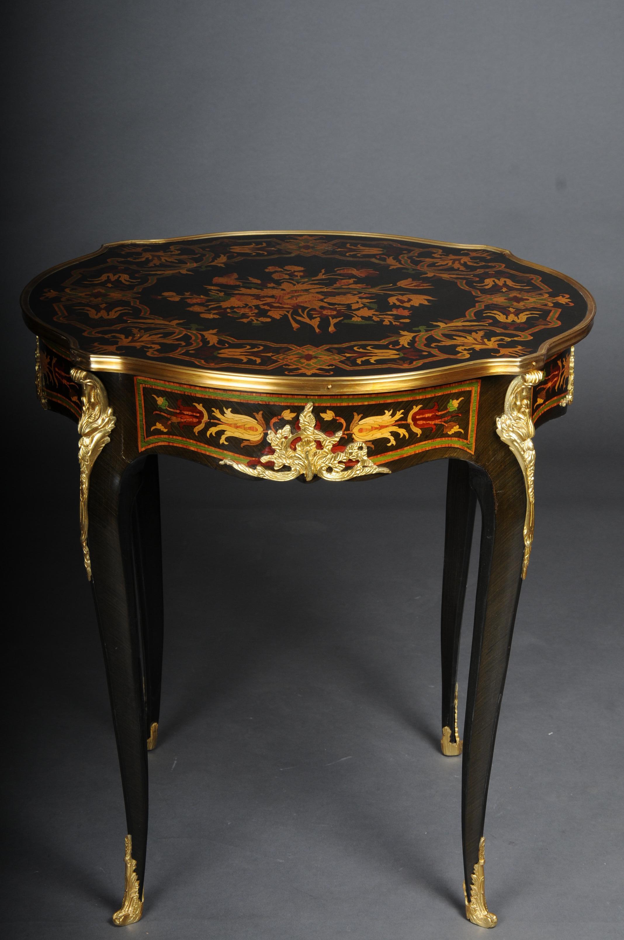 20th Century French side table / salon table, Louis XV, Marquetry

Bois-Satiné veneer, all-round mirror veneer and marquetry on beechwood. Set with finely chased, very decorative, pierced bronze fittings edged. Carcase box on sloping, curly legs