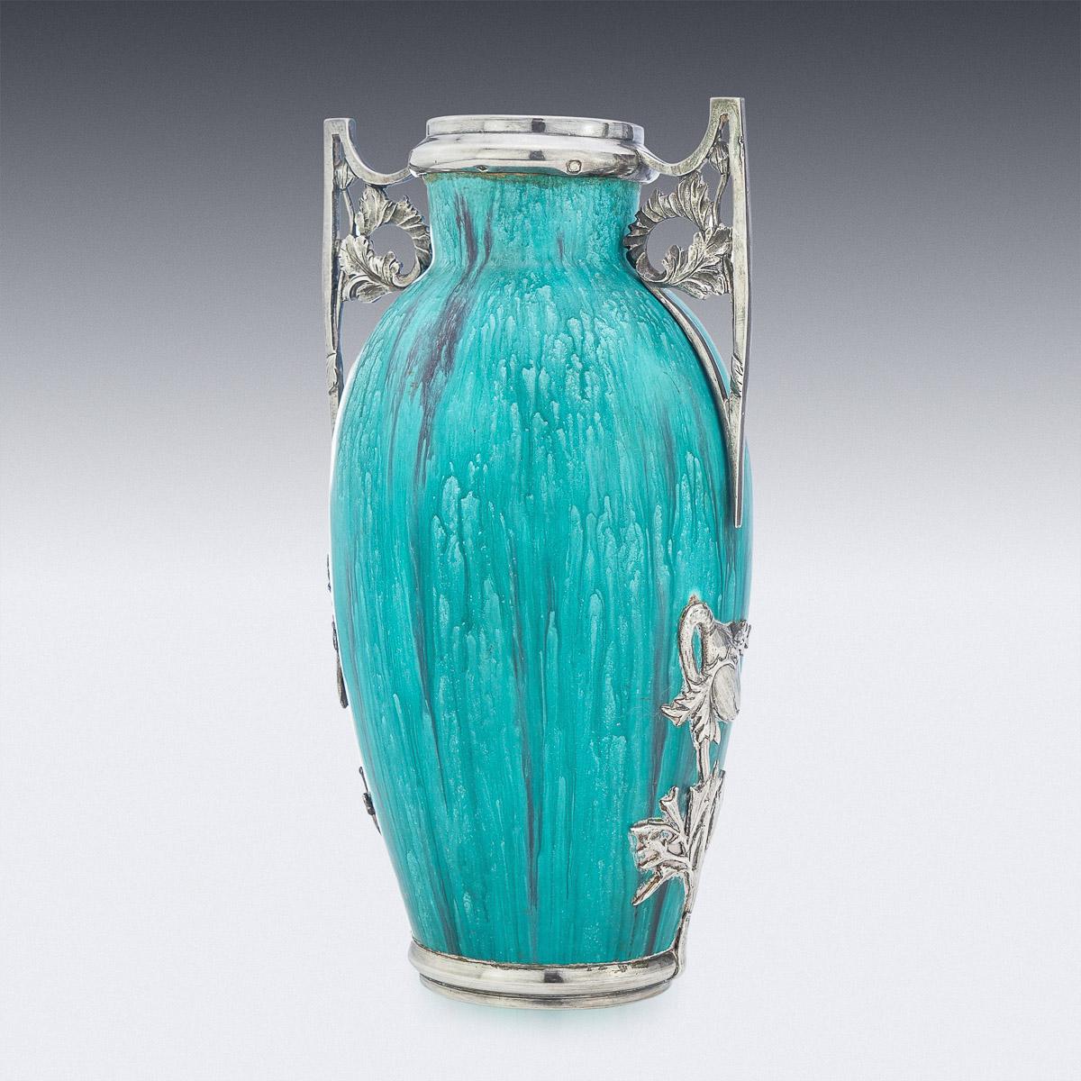 20th Century French silver mounted flambé glaze pottery vases, the neck and the circular foot are mounted with solid silver mounts featuring Art Nouveau decoration with shaped handles and flowers, mounted with a lovely aquamarine flambé glazed