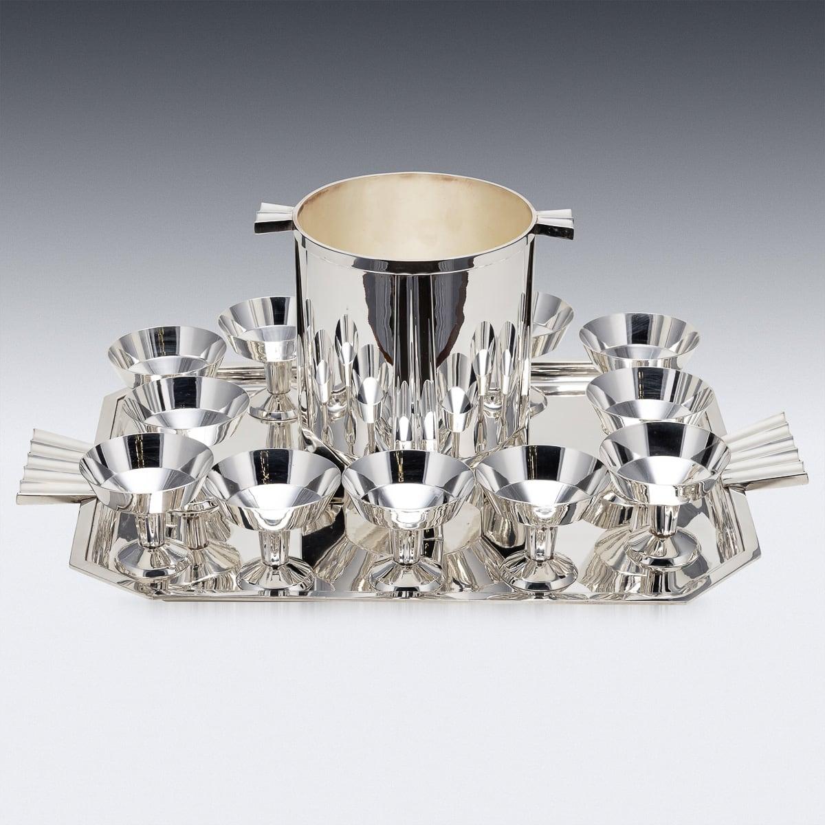 A stylish 20th Century French Art Deco silver plated cocktail set. Comprising of twelve goblets, a champagne cooler and a large serving tray. Perfect for hosting a cocktail party at home or entertaining guests after a large dinner.

CONDITION
In