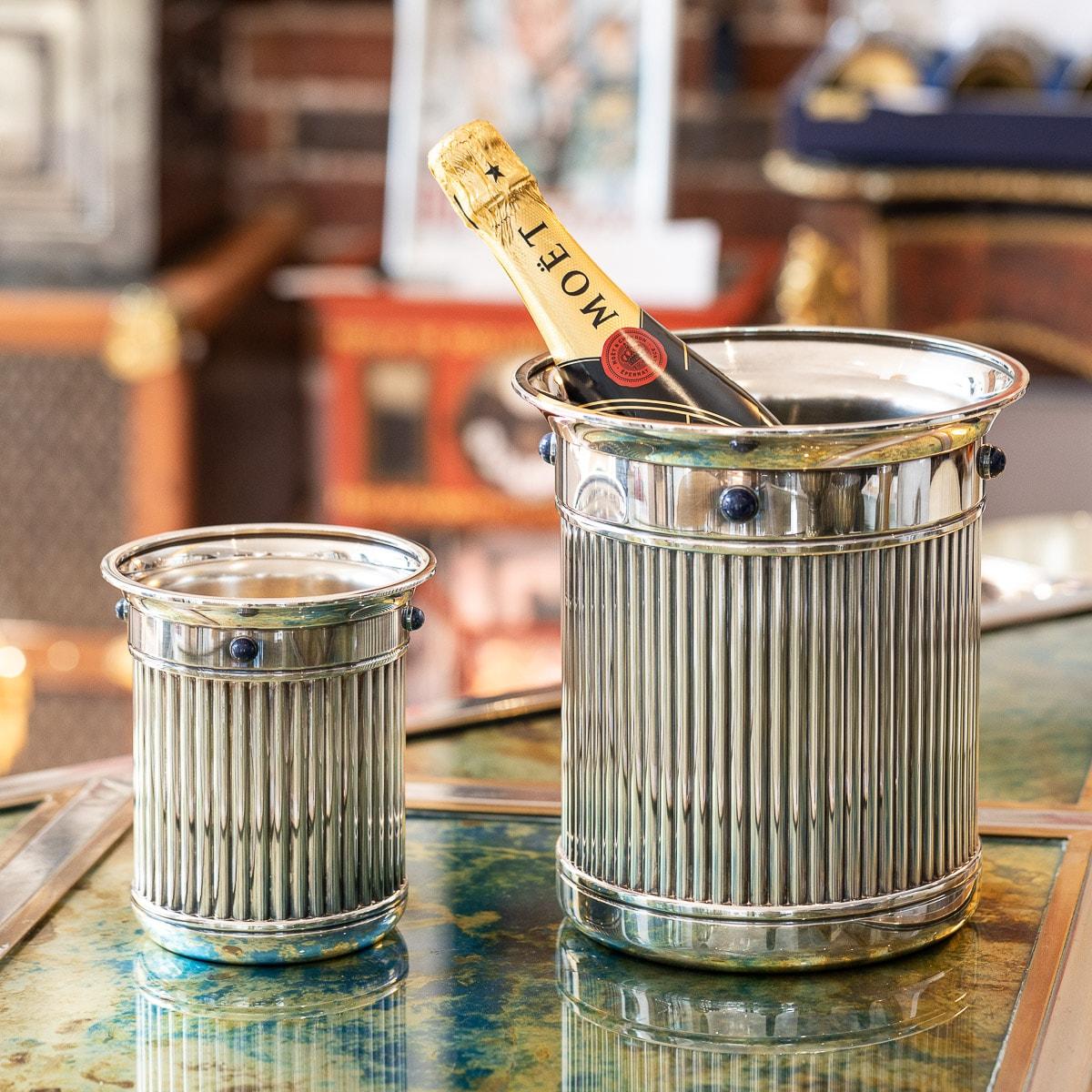 Stunning late-20th Century French silver plated champagne bottle cooler with liner and ice bucket, all with reeded sides and set with four lapis lazuli cabochons, with original paperwork. This fine set makes a fantastic statement piece and wonderful