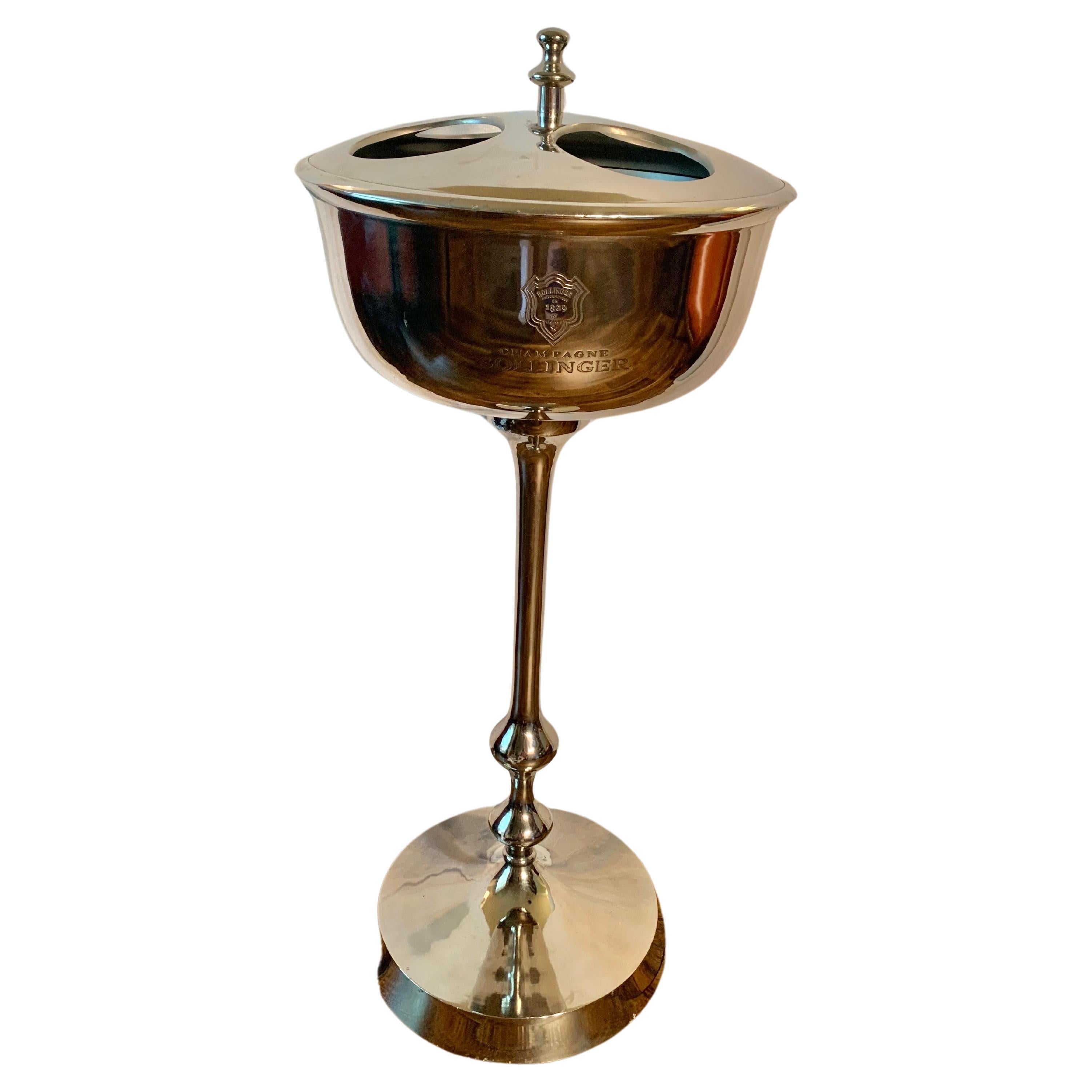 Found in the South of France, this 20th Century French Bollinger Champagne Chiller Stand was elegantly crafted from silverplate in the late 1900's. The piece is designed to hold four bottles and features a removable top for additional chilling. The