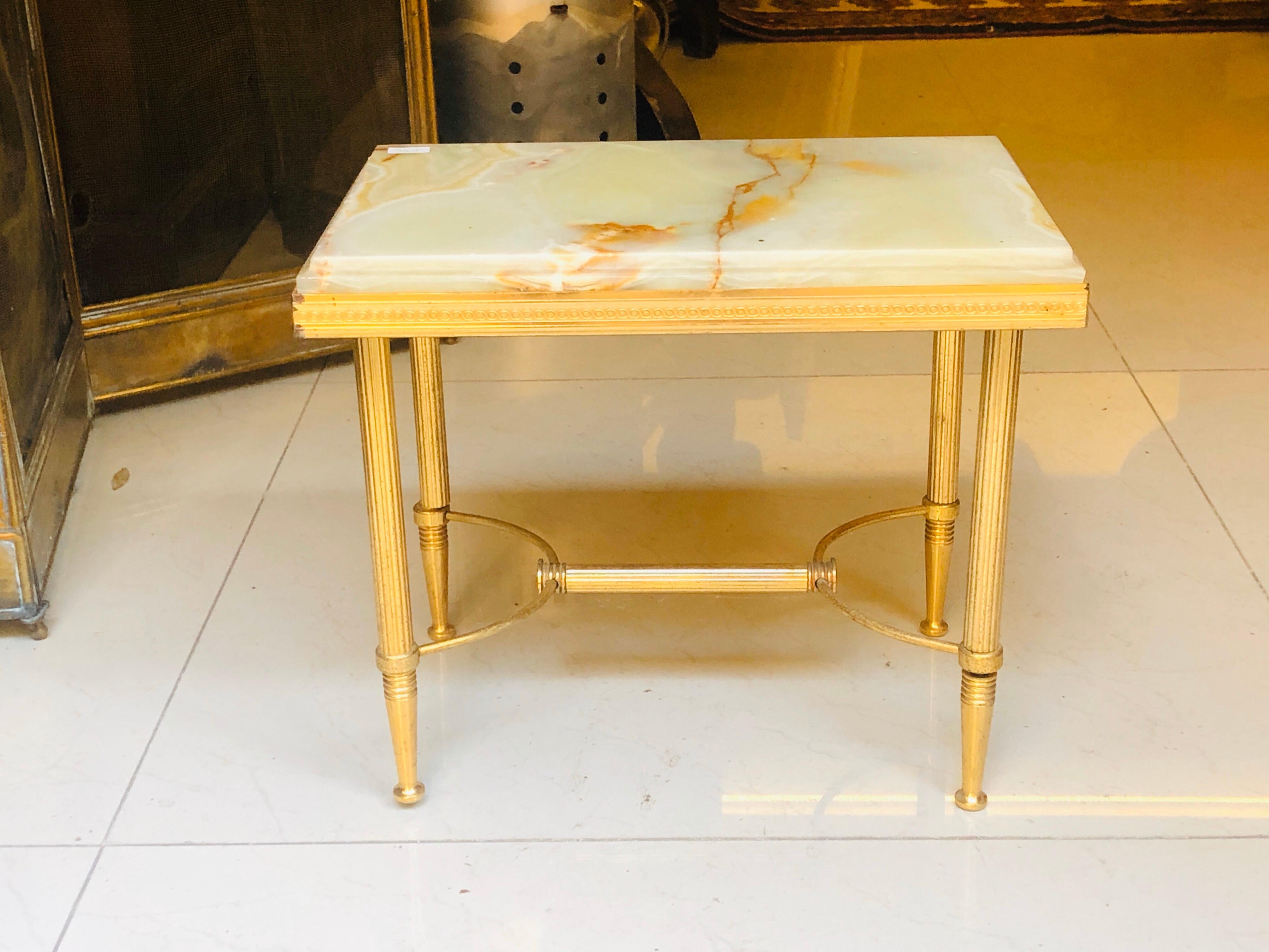 Small and elegant tray table with brass crossed legs and marble top in light beige.
France, circa 1930.