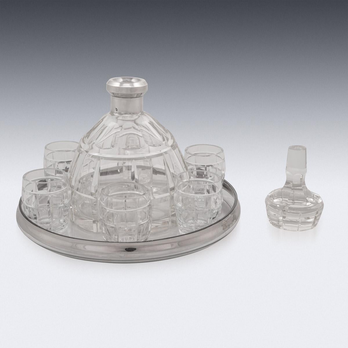 Stylish mid-20th century French solid silver mounted on glass decanter, 6 shot glasses and a tray. Of very unusual design, imitating the shape and pattern of a hand grenade, mid-size with deep cut glass body and mounted with a geometrical stopper.