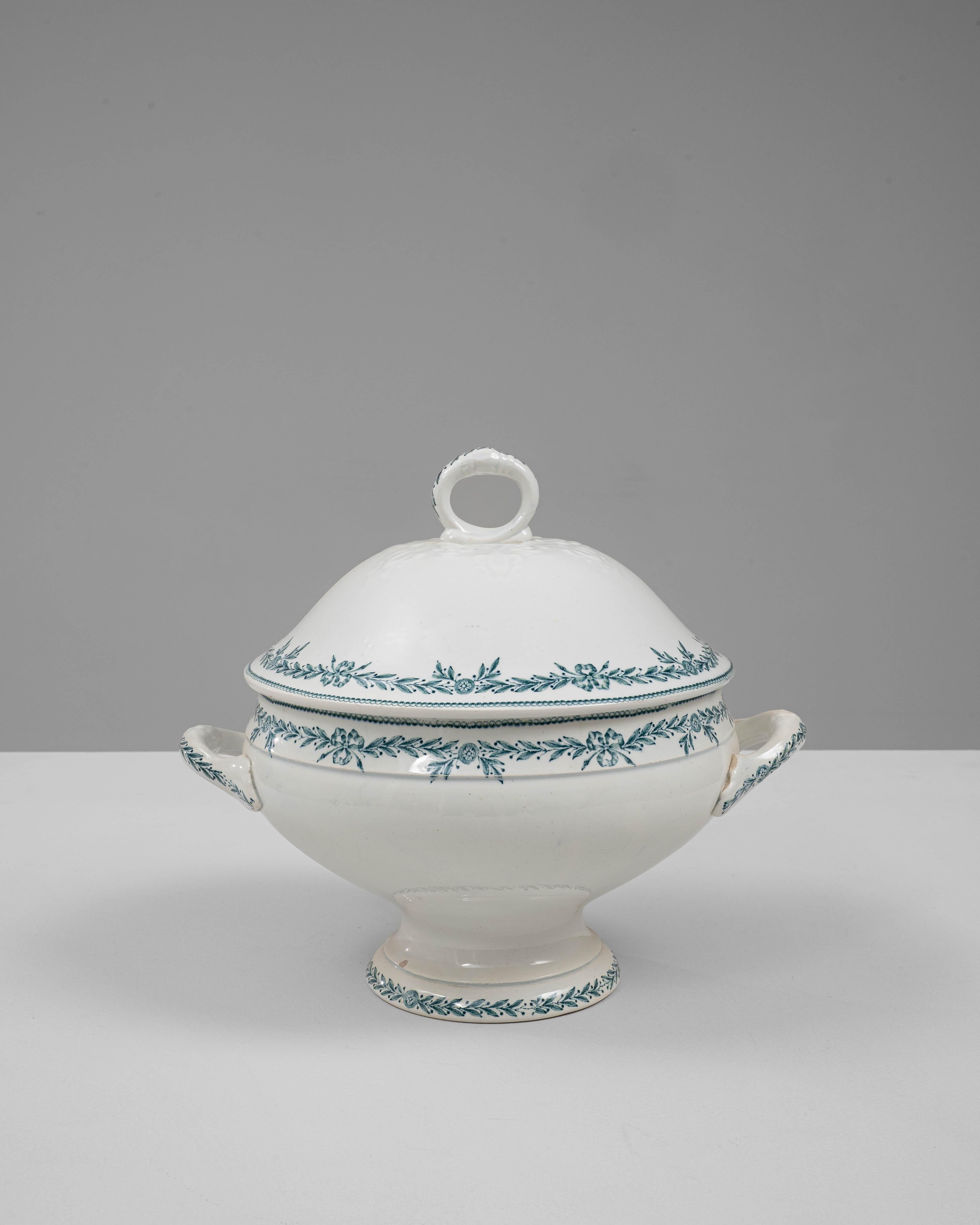 This 20th Century French special edition porcelain tureen with lid reflects the elegance and refinement of traditional French tableware. Crafted in creamy white porcelain, the piece features a gracefully rounded silhouette elevated on a pedestal
