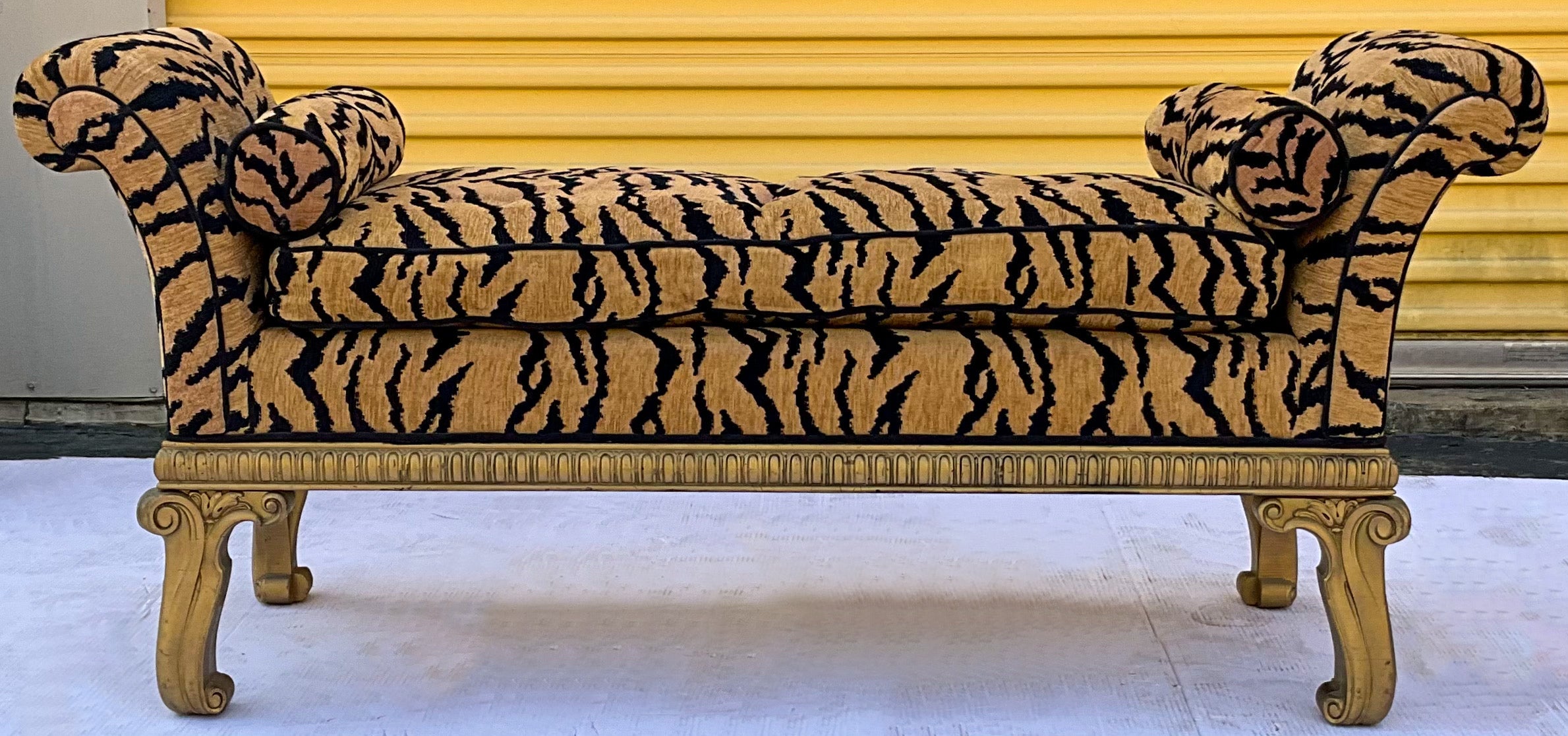 This is a late 20th century carved giltwood bench in tiger upholstery. The upholstery feels like chenille and is vintage. It is unmarked and in very good condition. The piece is most likely Italian.


