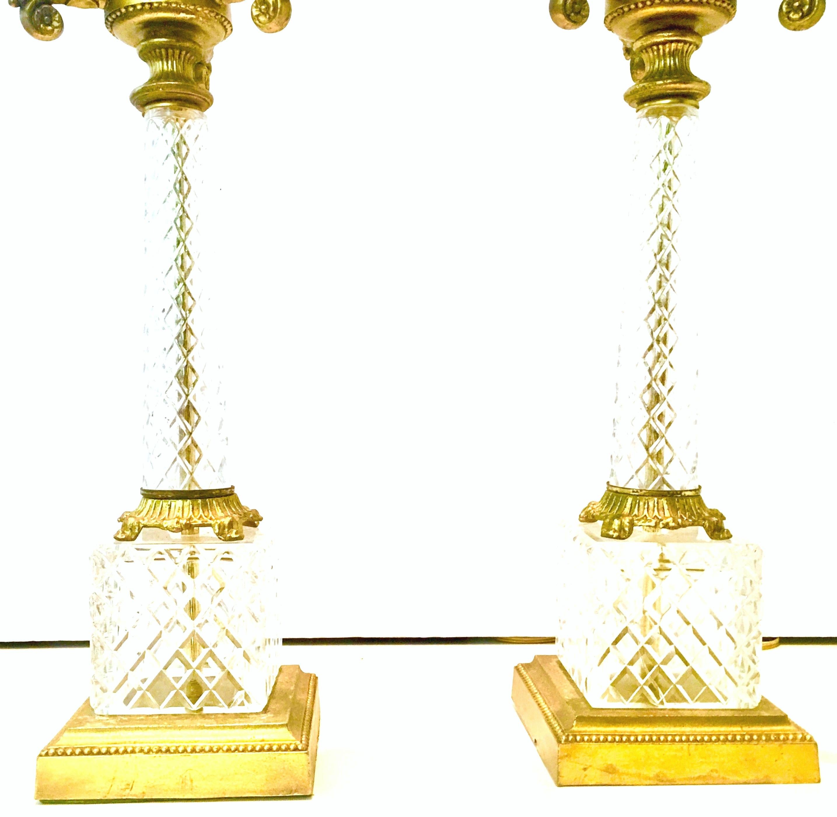 20th century French style, three-light candelabra diamond cut crystal and gilt bronze mount table lamps. Features clear diamond cut crystal bodies with a square gilt bronze bottom base and slender elegant necks. Decorative gilt bronze mounts