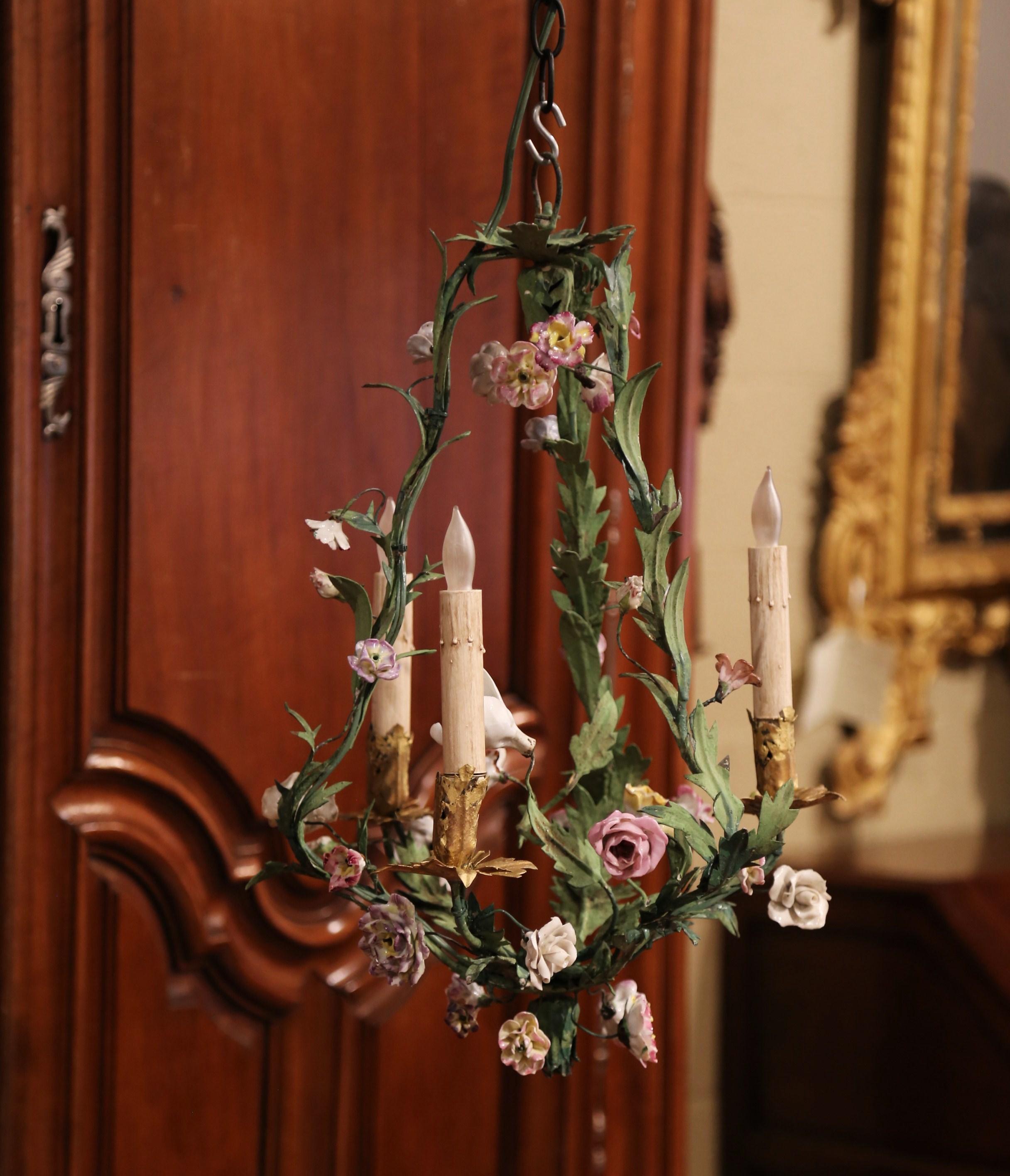 Decorate a girl bedroom or a powder room with this petite antique light fixture; crafted in France, circa 1900, the delicate chandelier features three lights newly wired and is embellished with white, pink and yellow porcelain flowers surrounded by