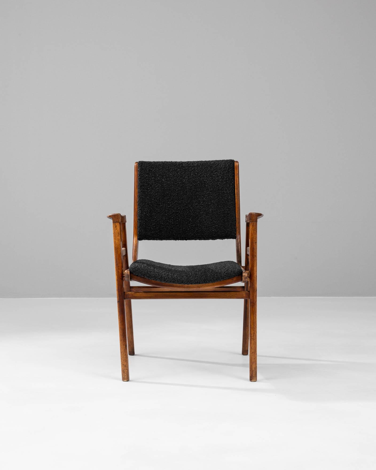 Discover the epitome of mid-century sophistication with this 20th Century French Upholstered Chair, a striking addition to any modern home or office. Crafted with an eye for timeless design, this chair features sleek, angular wooden arms and legs