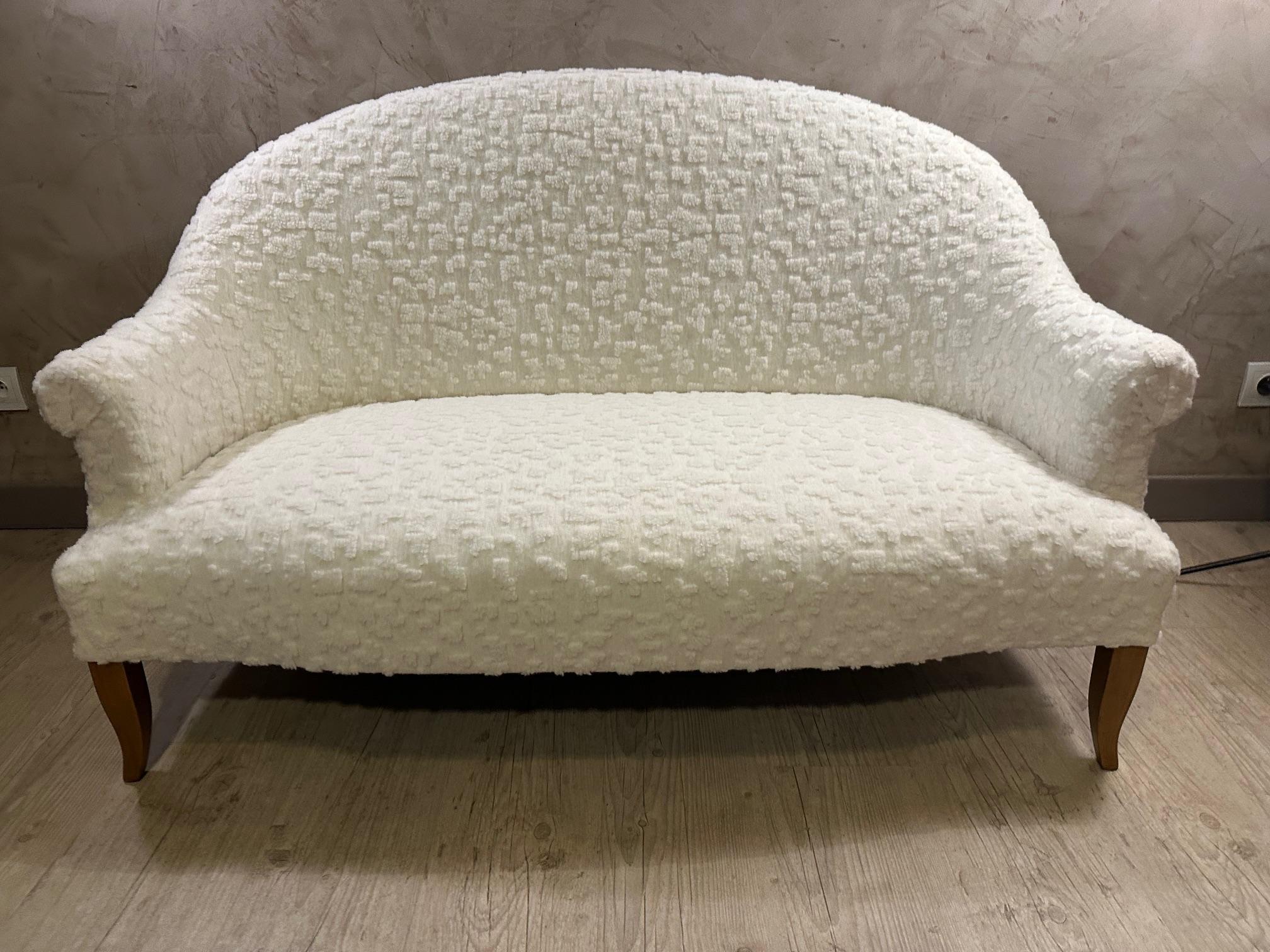 Very beautiful two-seater crapaud sofa that has been reupholstered by ourselves (we are also upholsterer) with a beautiful wool fabric as soft as sheep produced by the Larsen fabric house. Raw wooden legs. 
Very comfortable. Ideal in a small living