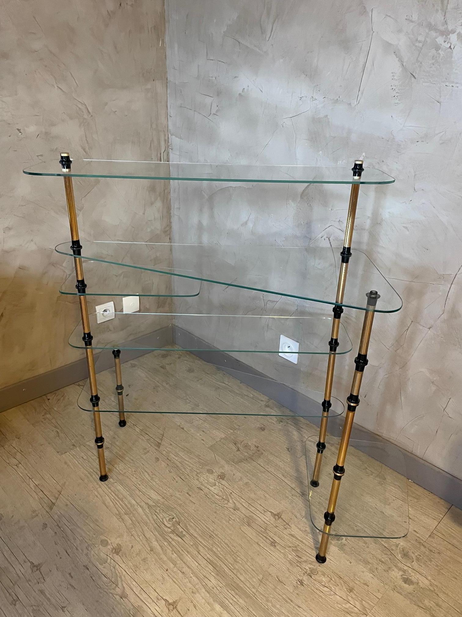 20th Century French vintage shelf made with a metal and brass base and 6 glass shelves. The second glass shelf from the top can be moved. 
Very good condition, just one brass mouthpiece is missing.
 