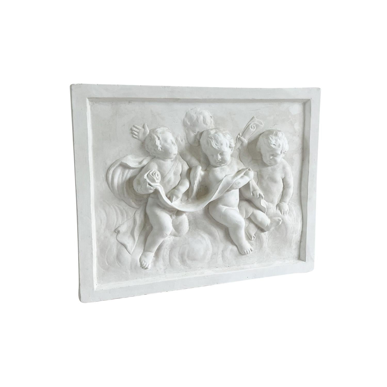 Un piccolo rilievo da parete vintage in gesso francese, ispirato a un rilievo originale francese del XVIII secolo con quattro cherubini e circondato da una cornice in gesso, in buone condizioni. Non è consigliato per l'uso esterno. Leggero