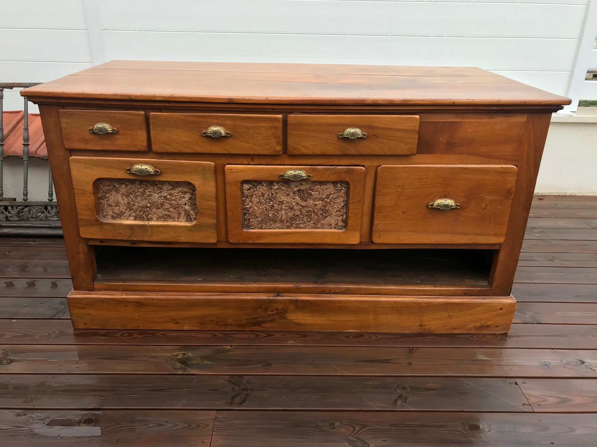 Exceptionnal 20th century French walnut apothecary cabinet or chest of drawer from the 1900s. 
One side has many drawers and the other side has also drawers and a large opening space on the bottom. Would be perfect in a kitchen or to separate a