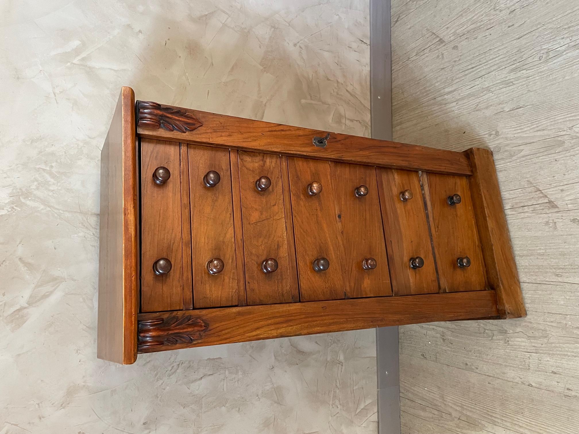 Pretty 1920 walnut semainier chest of drawer with flap on the right with lock to close all the drawers. Nice quality.