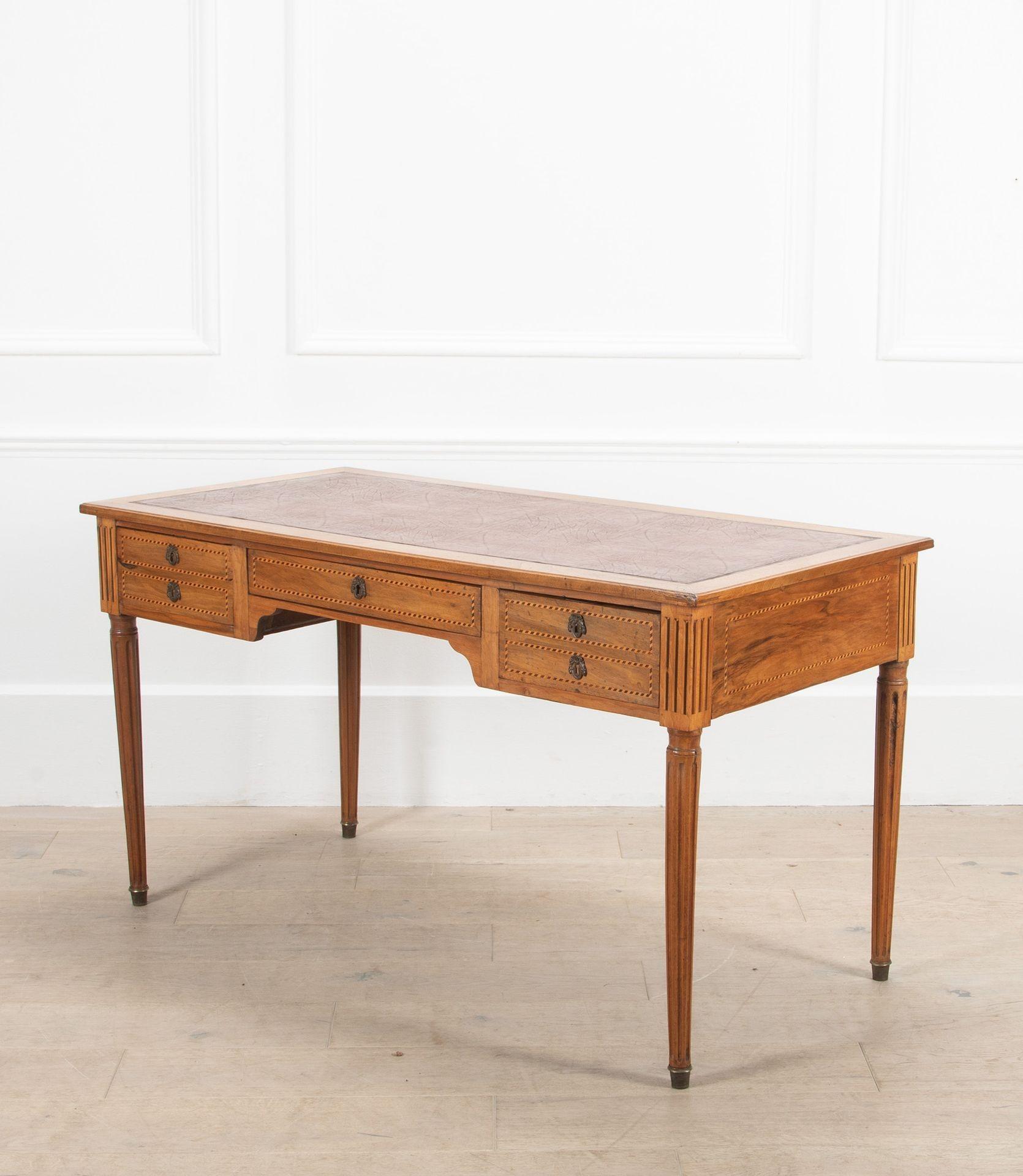 French 20th Century walnut bureau plat desk with leather inset.

This beautiful desk is decorated with inlay and comes with a useful chair with cane seat.