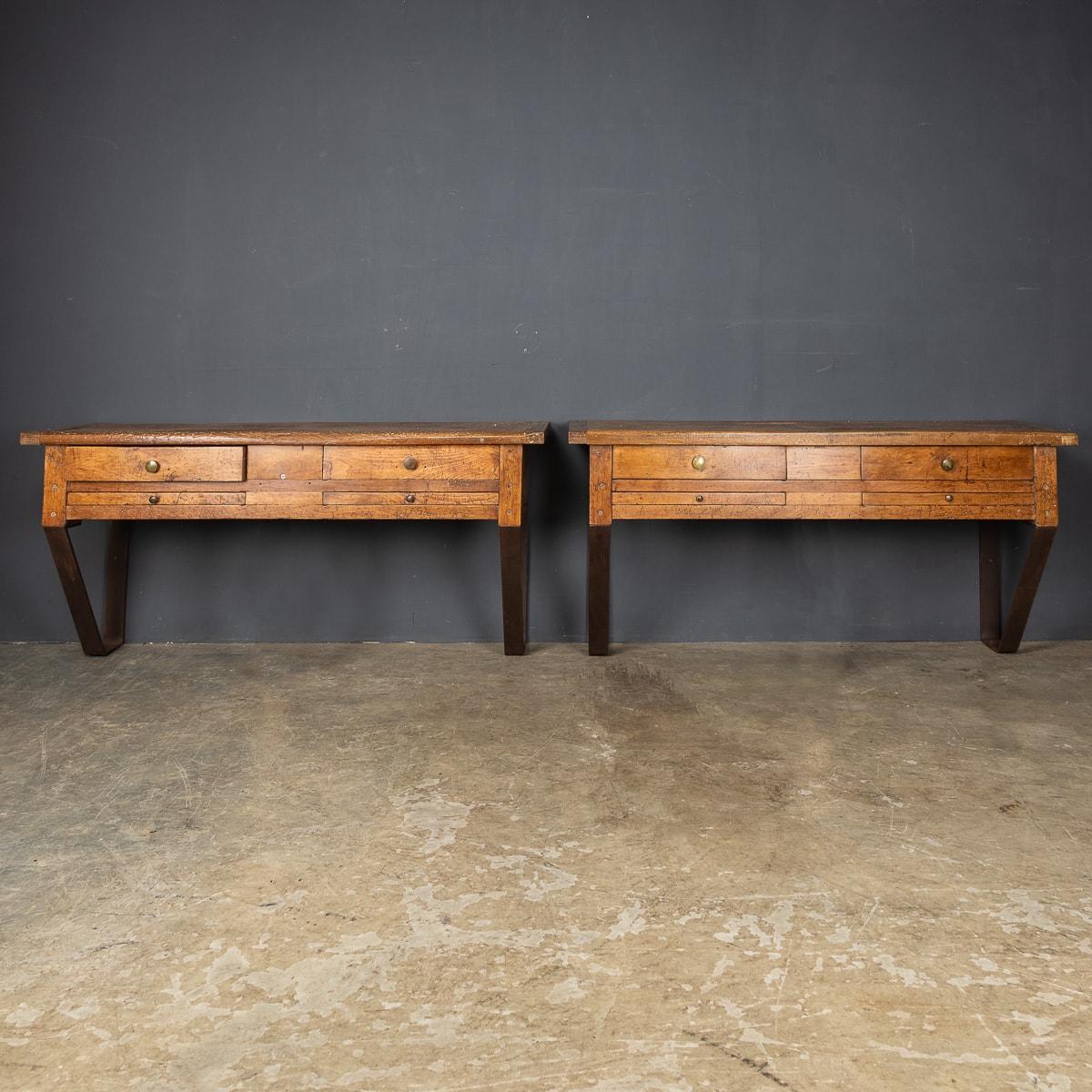 Antique 20th century French pair of jewellery makers work benches, in walnut with four drawers and a supporting metal legs.

Condition
In Good Condition - wear consistent with age.

Size
Height: 71cm
Width: 147cm
Depth: 49cm.