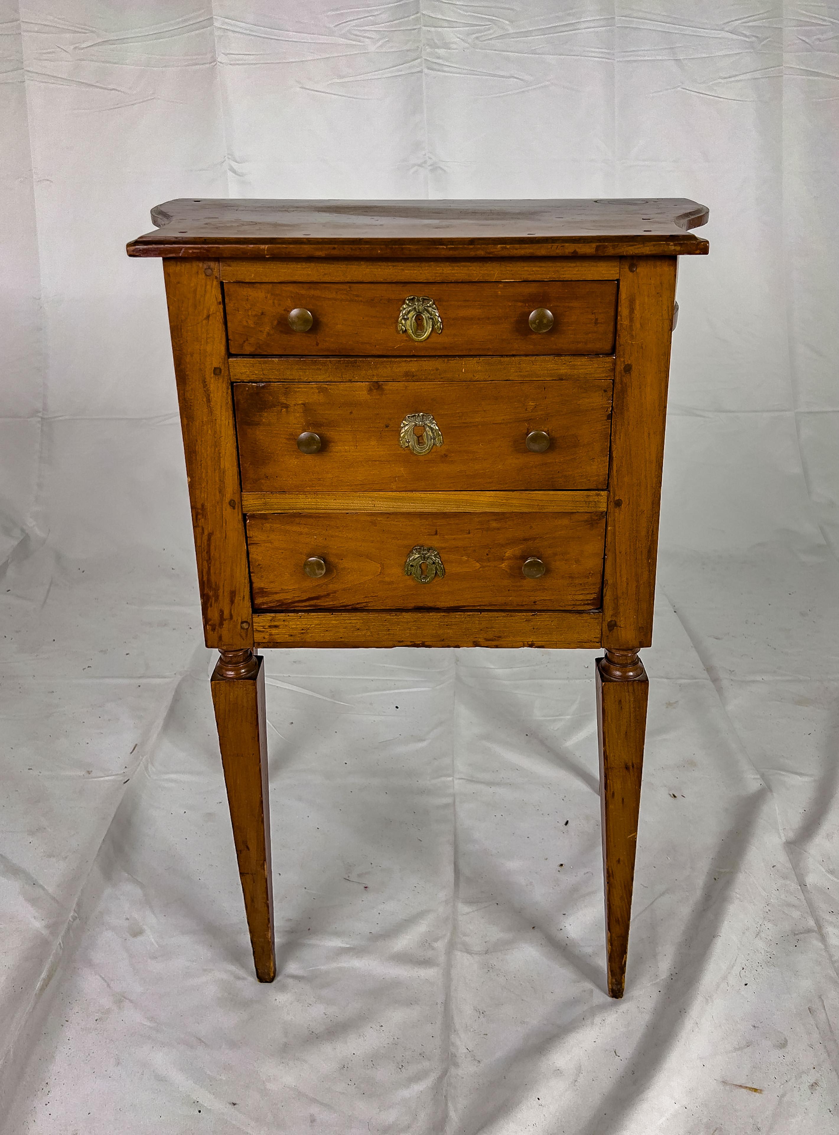 20th Century French Walnut Side Table with three drawers, shaped sides and straight tapered legs. This piece has a very mellow and rich patina.