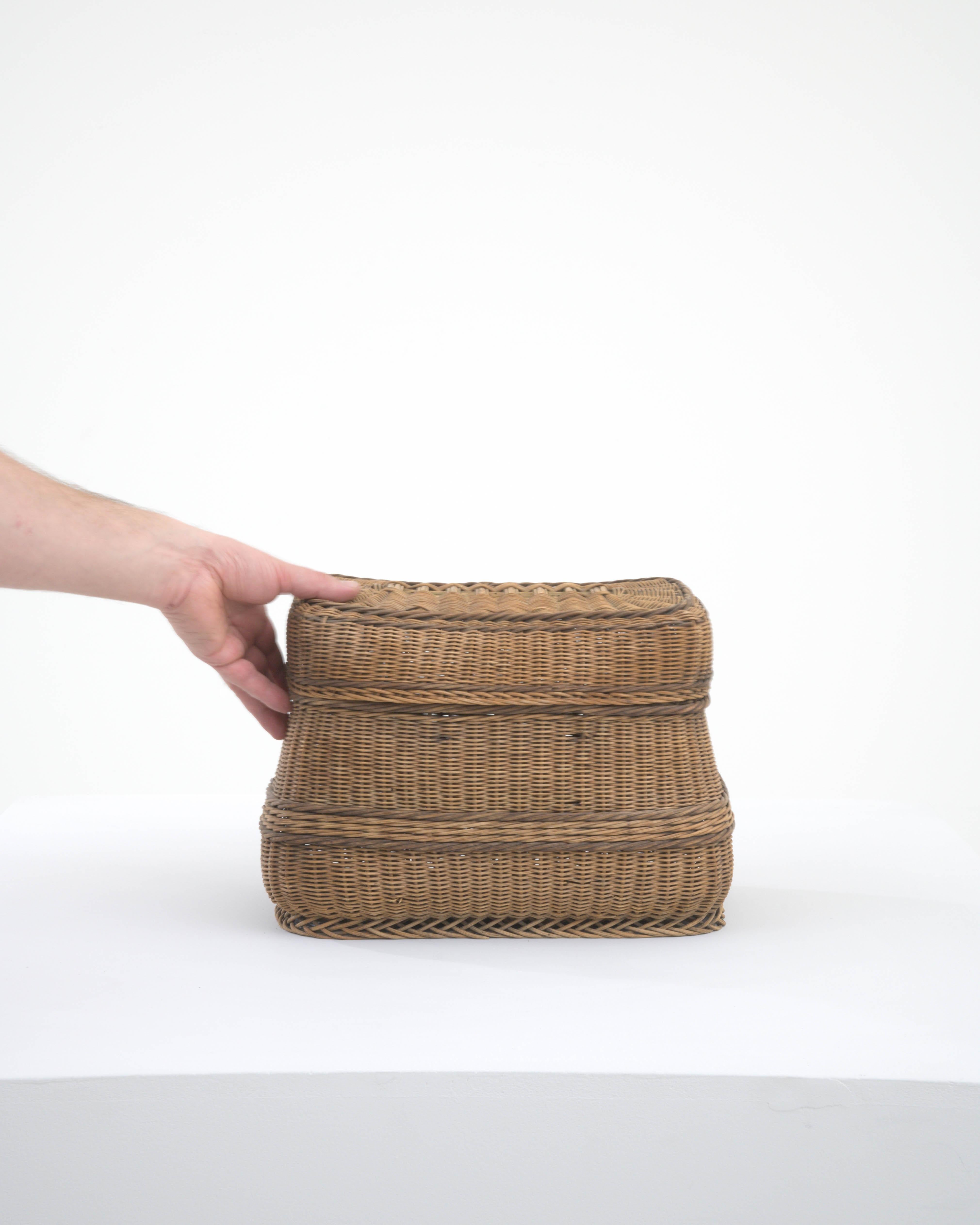 Discover the rustic charm of this 20th Century French Wicker Basket, a versatile and timeless addition to your home decor. Handwoven with meticulous care, this basket showcases the intricate craftsmanship of traditional wicker techniques. The