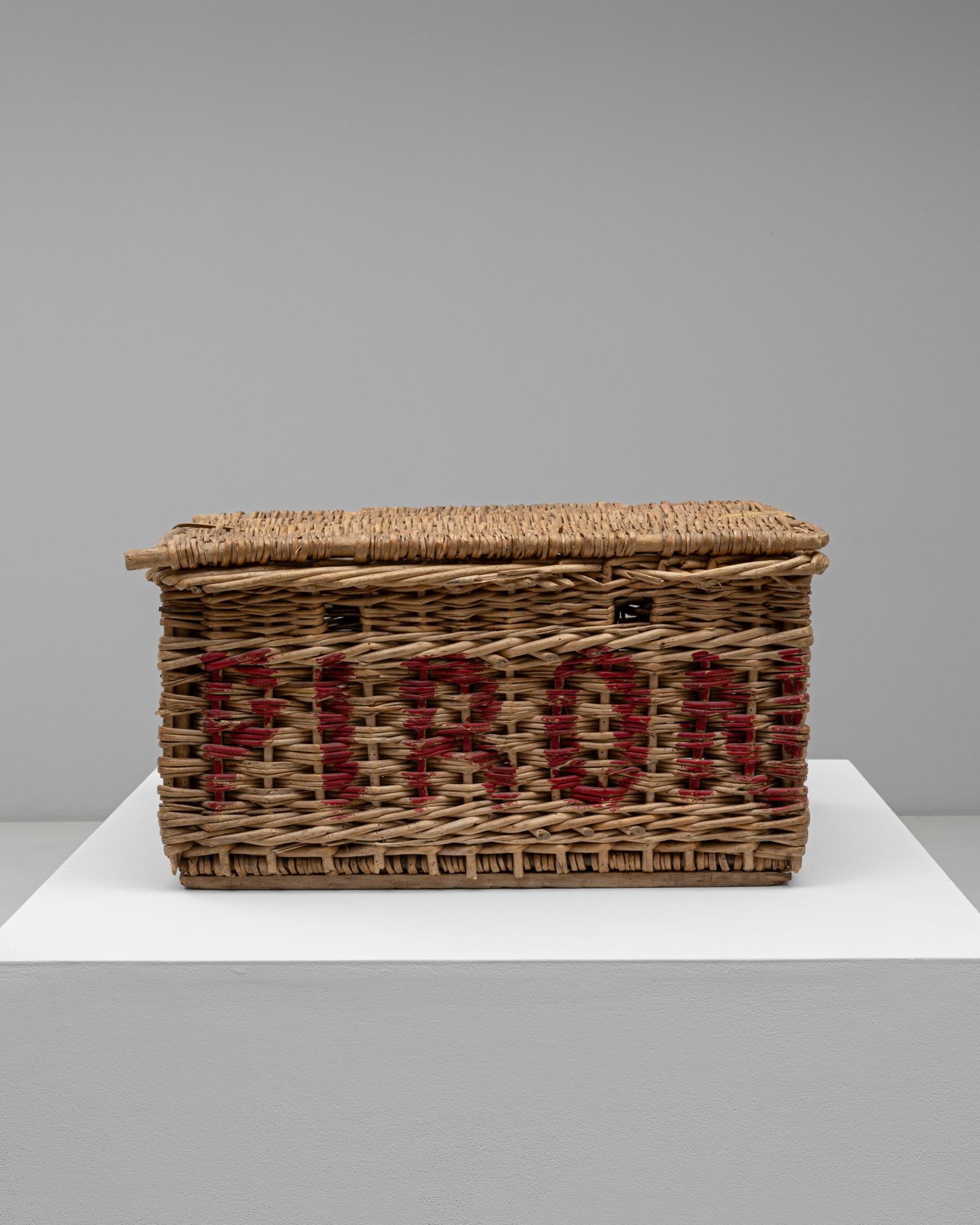 This 20th Century French wicker trunk captures the authentic craftsmanship and charm of rural French design. Handwoven from natural wicker, it features a hinged lid and sturdy construction, ideal for both decorative and practical use. The woven red