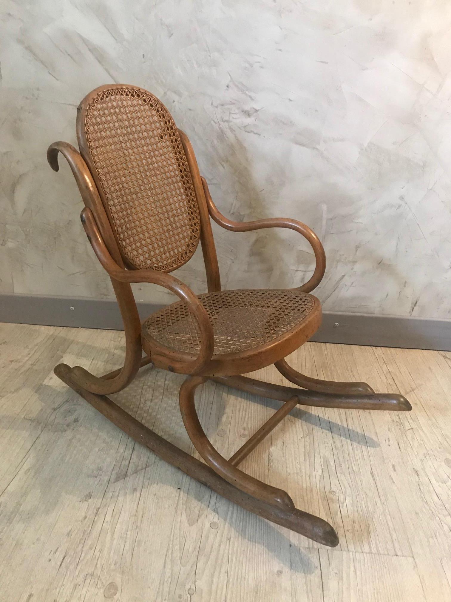 Very nice and rare 20th century French wood and cane child rocking chair from the 1920s. 
Caned seating and back. In the style of Thonet. 
Show some consistent with age and use but good general condition.
Very nice quality.