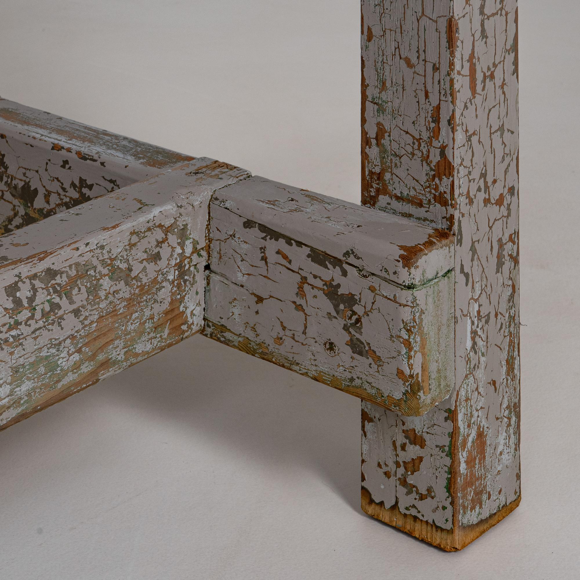 20th Century French Wood Patinated Dining Table. This character-rich French dining table features a beautifully aged patinated finish that speaks to decades of use and natural wear. Its long rectangular top rests on sturdy square legs connected by a