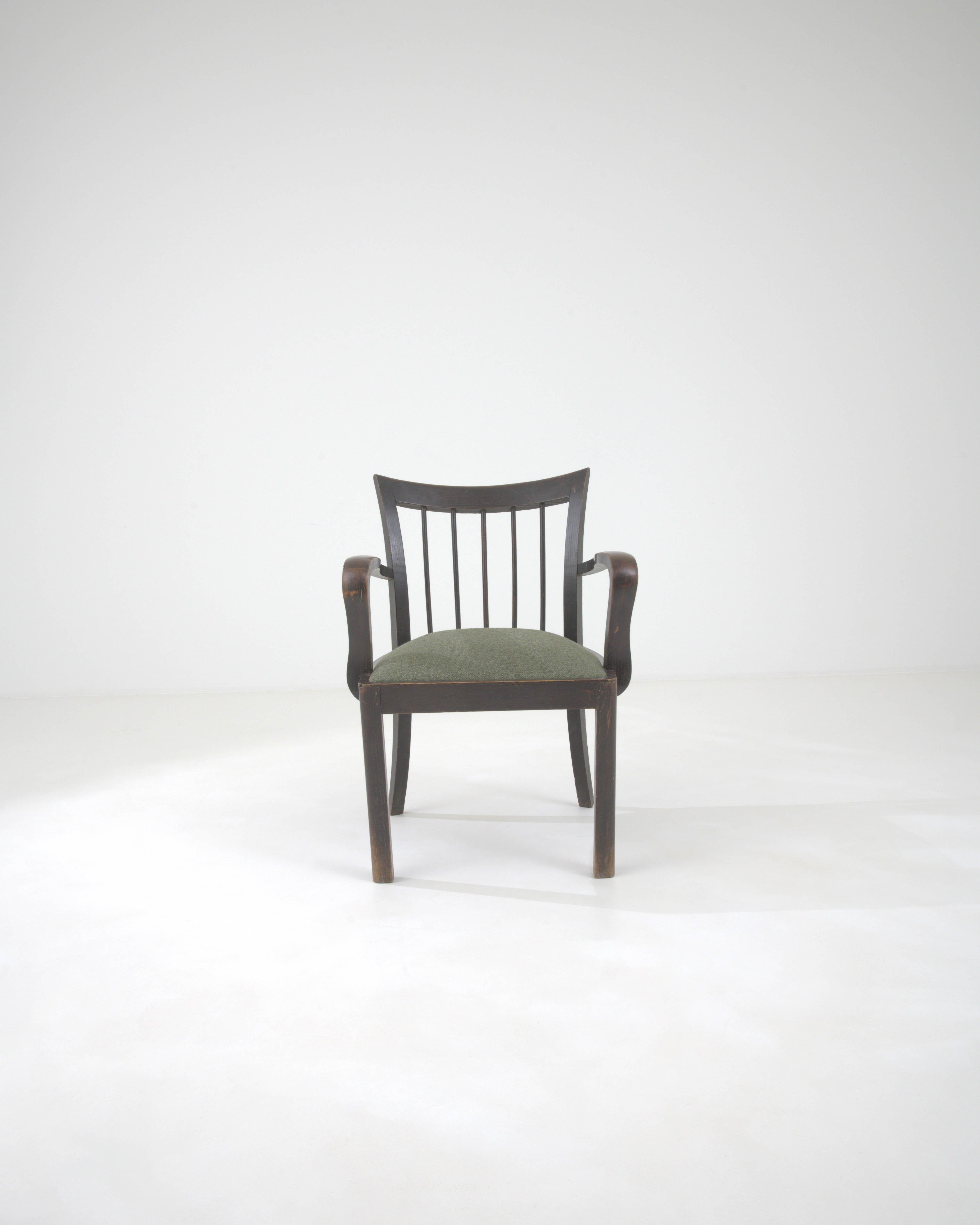 Experience the classic elegance of the 20th Century French Wooden Armchair, a piece that exudes timeless charm and sophistication. The chair's dark, rich wooden frame is masterfully crafted with a graceful curvature, providing an inviting outline