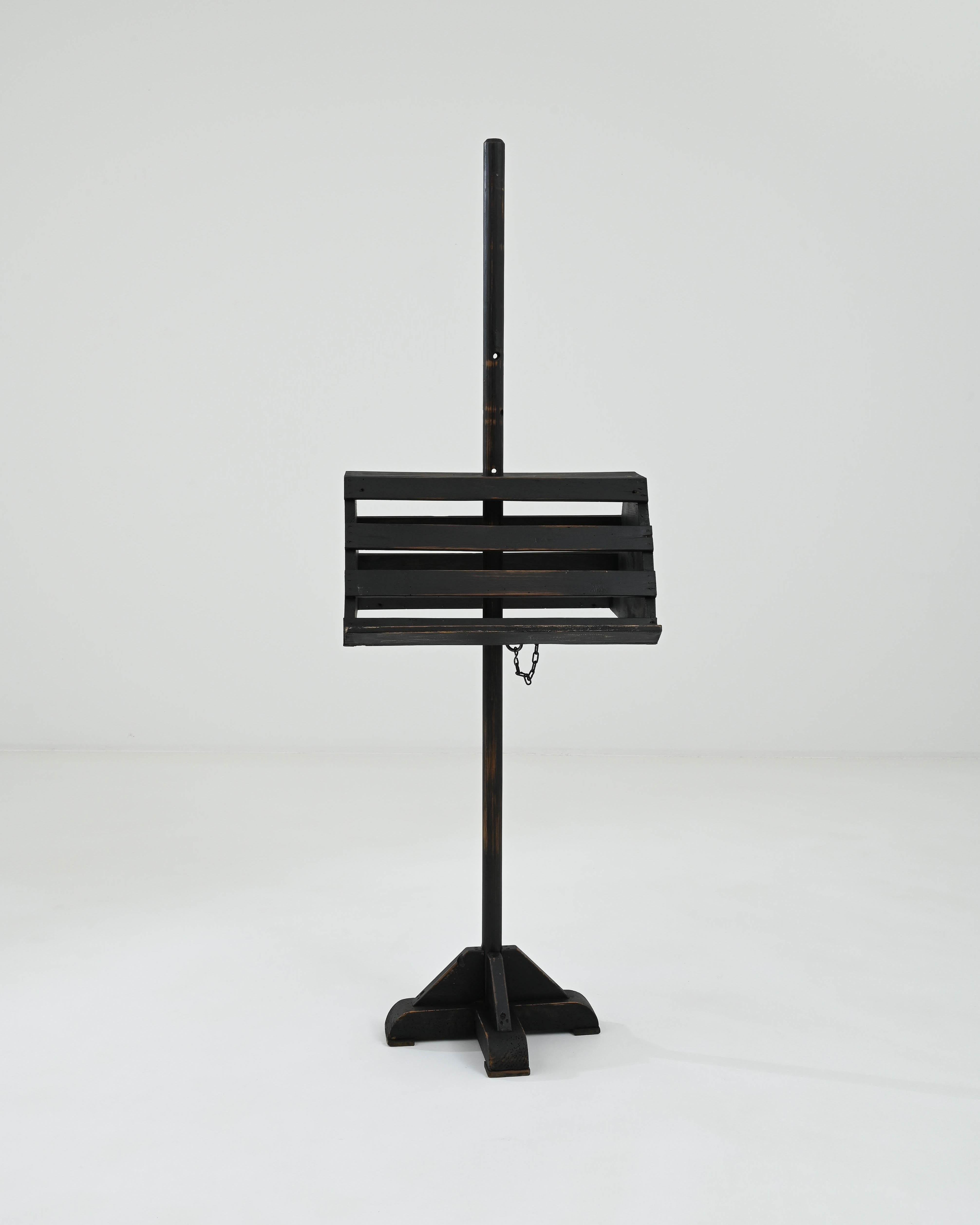 Enhance your reading experience with this 20th Century French Wooden Book Stand, showcasing a distinguished black patina. The stand's adjustable height provides flexibility, catering to your preferred reading angle. Its sturdy construction features