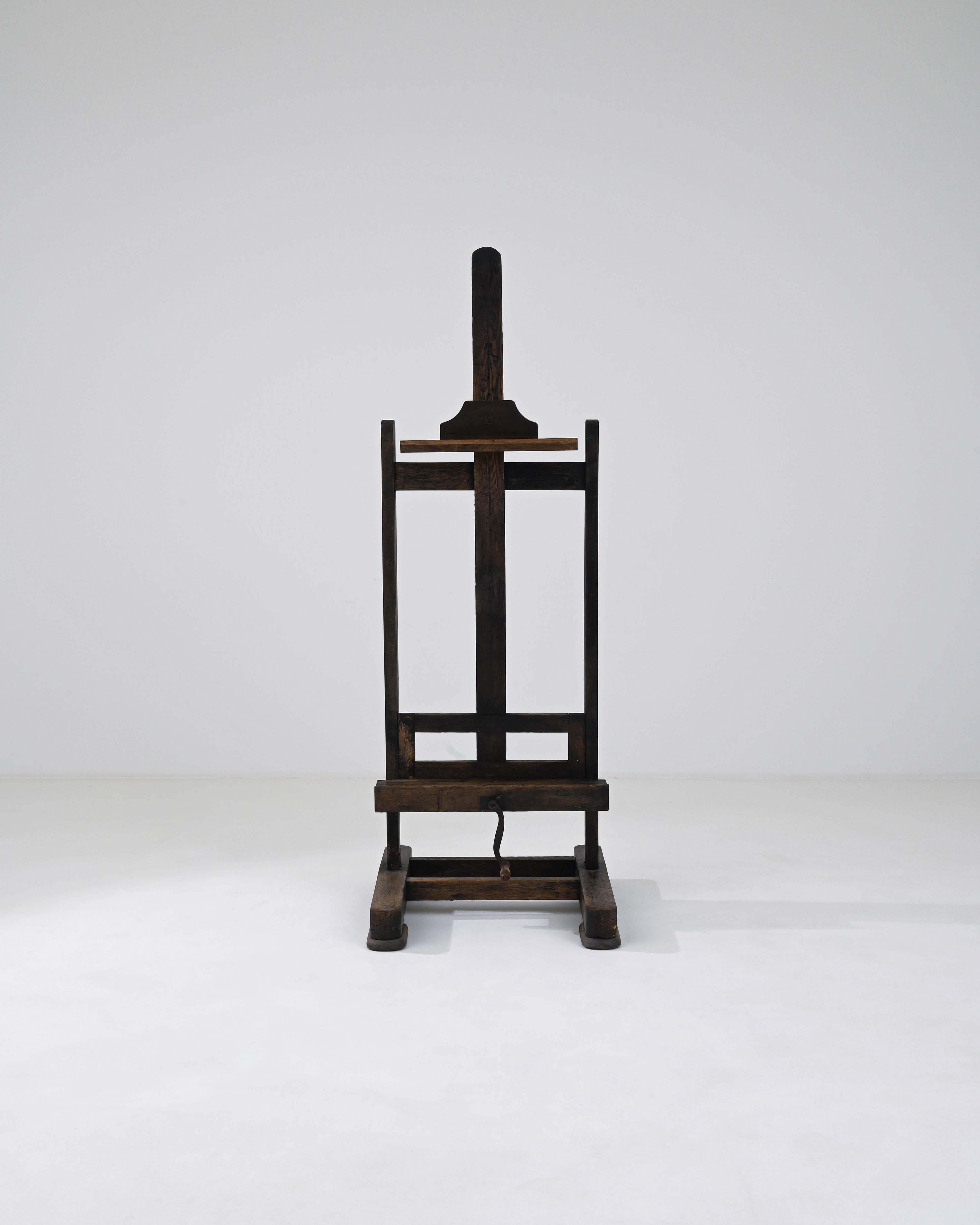 This wooden easel provides a bohemian accent or a practical accessory with a nostalgic touch. A wooden easel made in France during the 20th century, standing upright with a composed posture, this adjustable easel is ready for its next job. Warm,