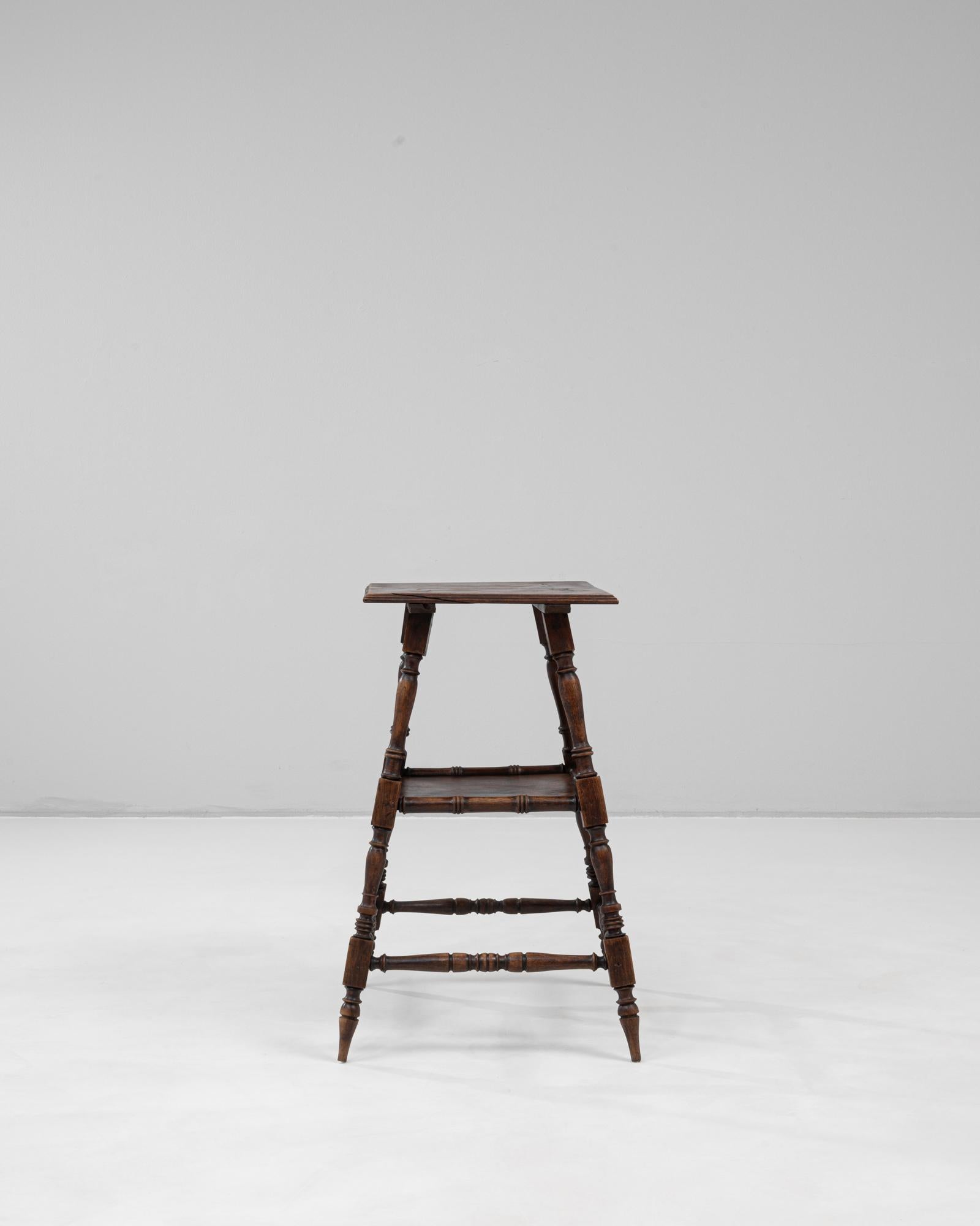 Piédestal en bois français du 20e siècle, patiné d'origine. Ce piédestal finement ouvragé met en valeur l'élégance de l'artisanat français avec ses pieds joliment tournés et ses supports à brancards. Conservant sa riche patine d'origine, la surface