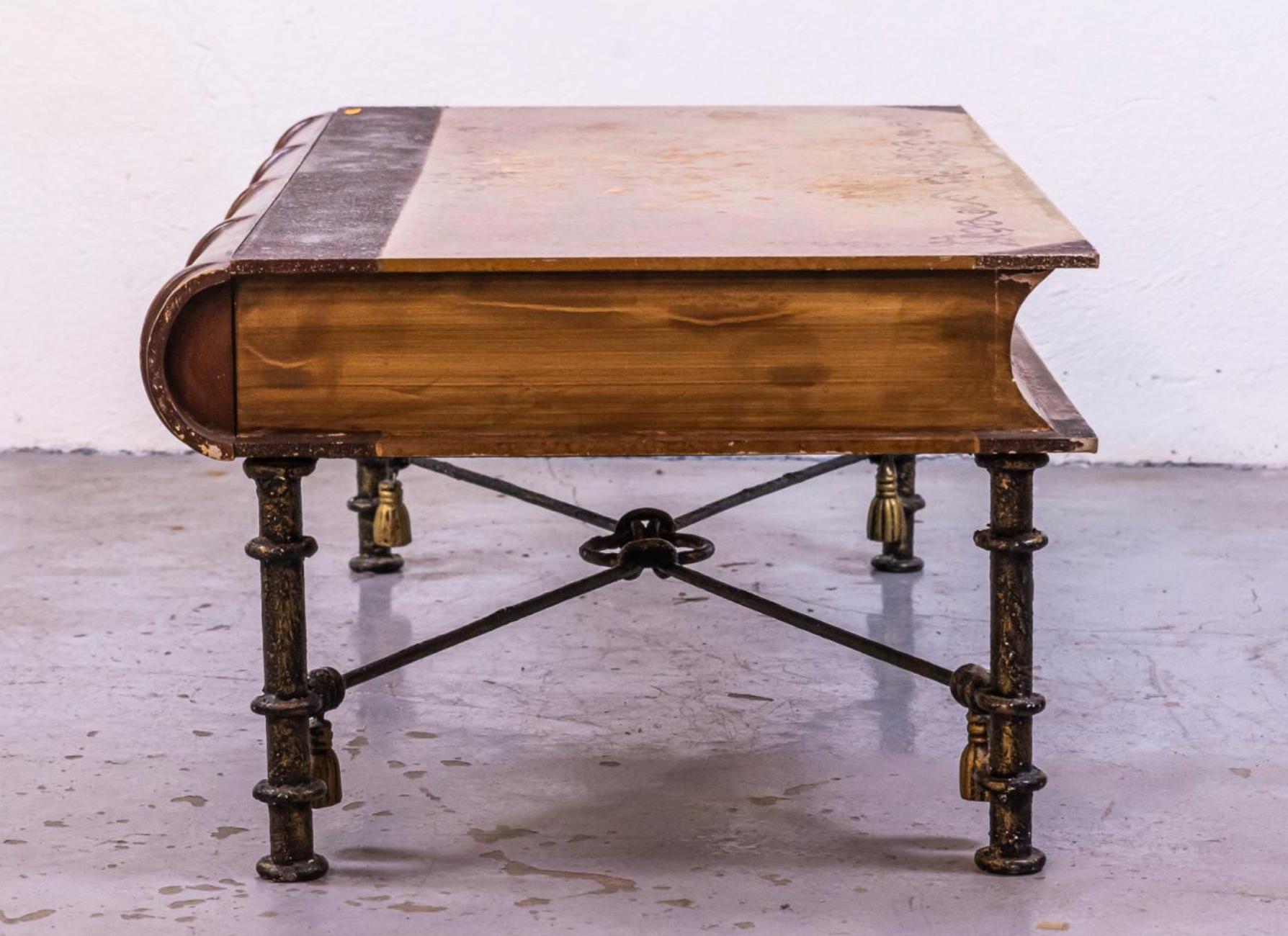 A very interesting small table that resembles an old book. It is made of solid wood resting on wrought iron legs with pompons as a decoration. The side of the book is actually quite big drawer.
France, circa 1930.