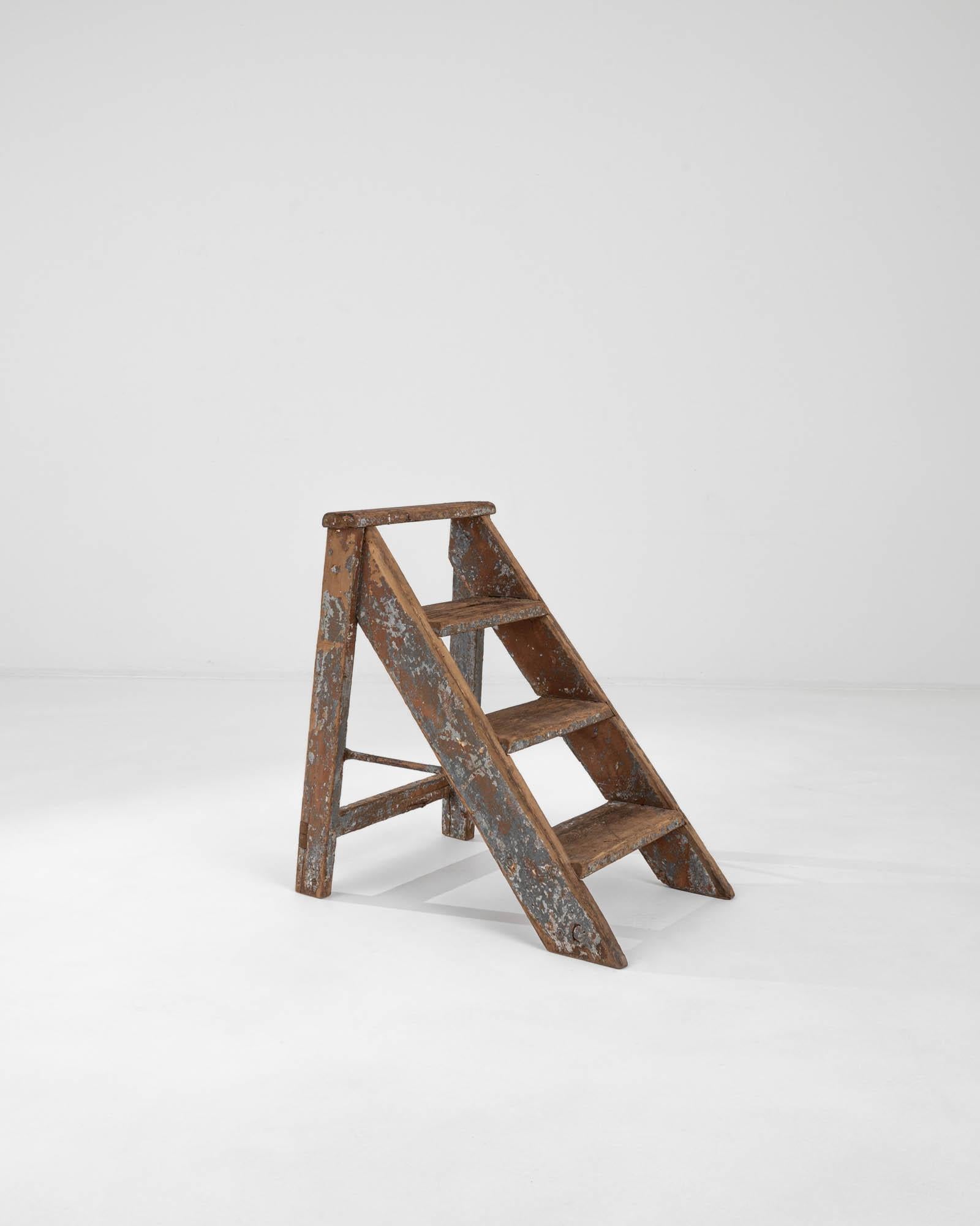 Step back in time with this charming vintage step ladder, a true testament to craftsmanship and enduring beauty. Hailing from the storied workshops of the French countryside, this ladder exudes simplicity and pleasing geometry that effortlessly