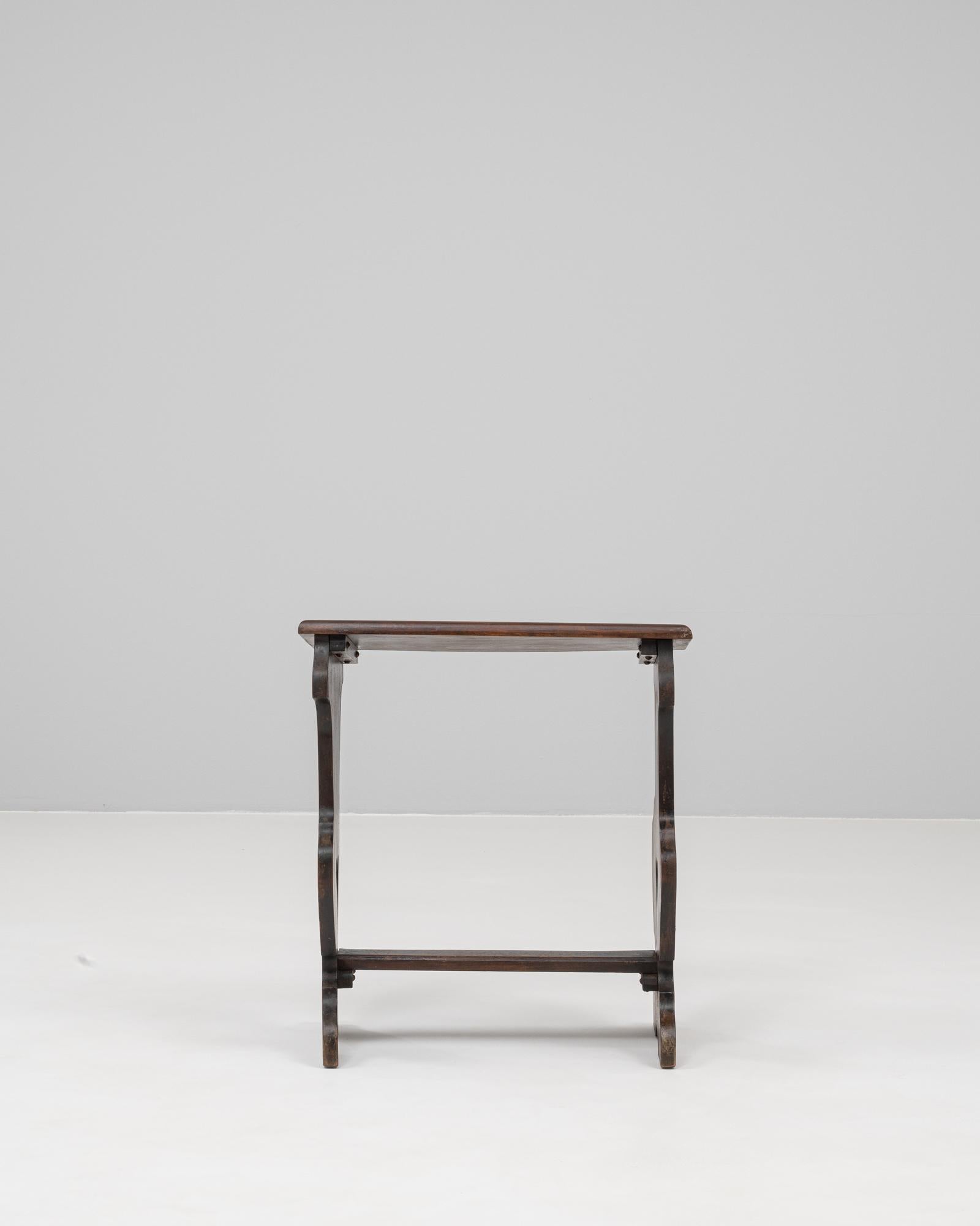 This 20th century French wooden stool features a charming hand-carved silhouette with heart-shaped cutouts, reflecting traditional Alpine craftsmanship. Constructed from solid wood, it showcases a deep, warm patina developed through time and use.