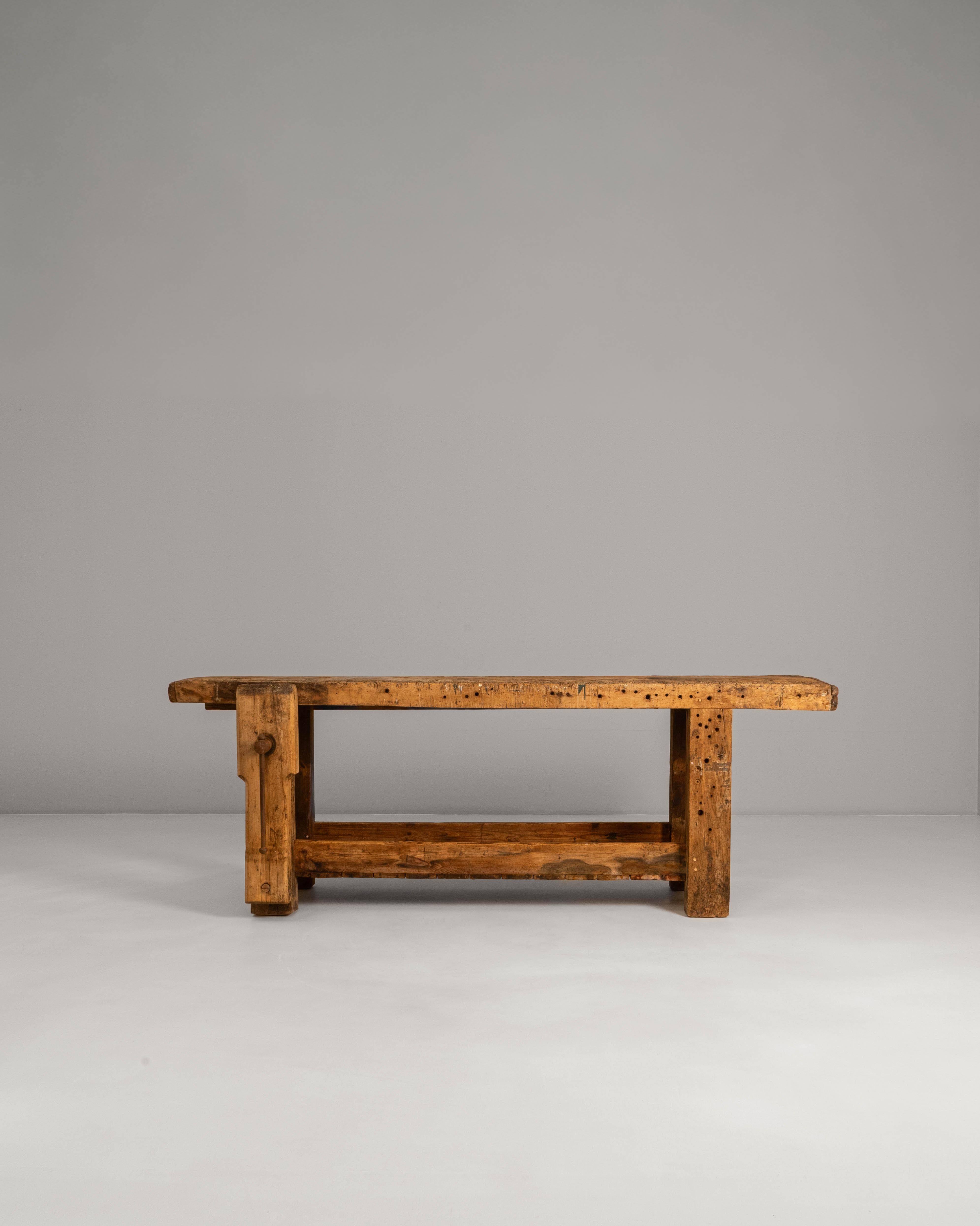 20th Century French Wooden Work Table. This robust French work table embodies the authenticity and utilitarian charm of early 20th-century craftsmanship, constructed from thick, solid timber with a richly worn surface that reveals decades of