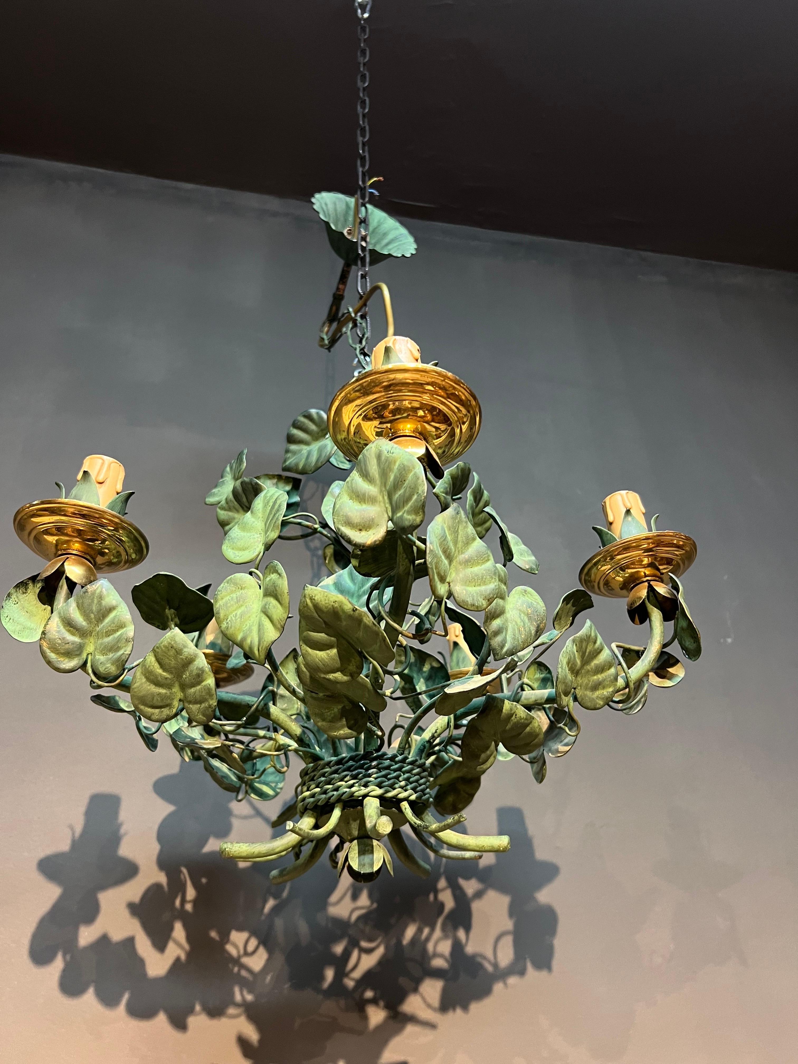 Beautiful French hand painted wrought iron chandelier with hand made and painted in green metal leaves. There are six bulbs on the top.
France