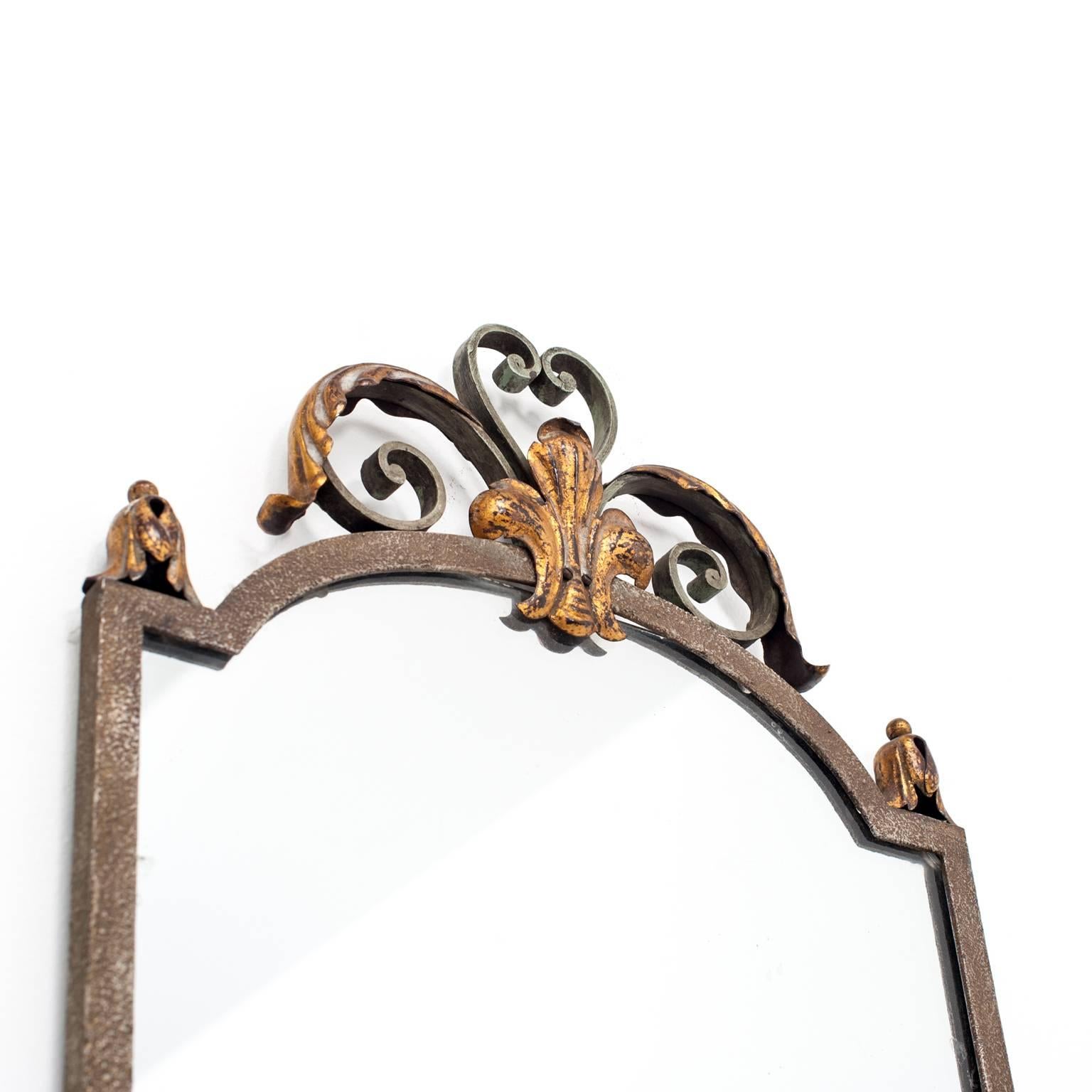 French mirror, manufactured in iron and gilt metal, with top acanthus leaf and scroll ornaments.