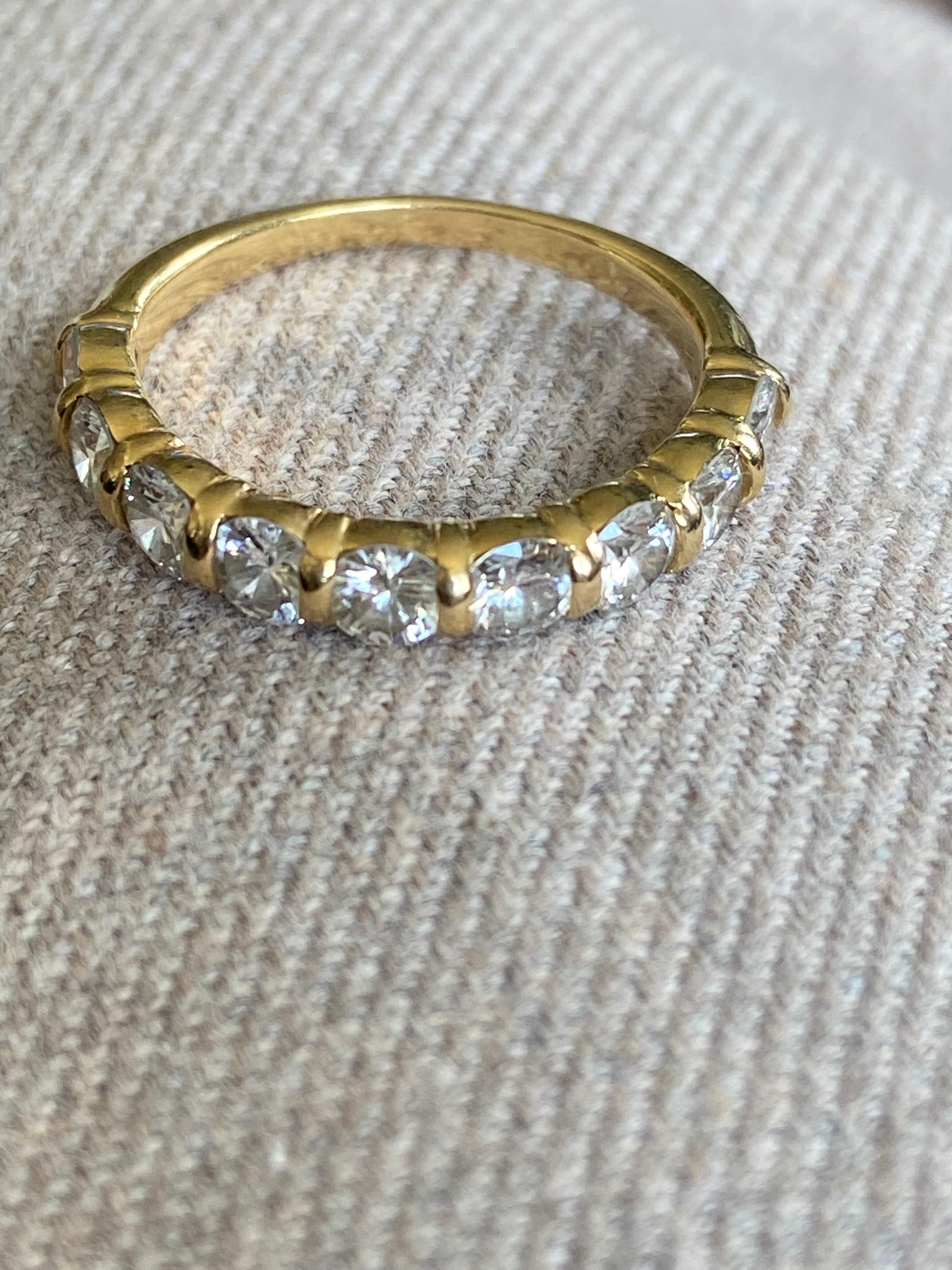 French alliance ring in yellow gold with nine round diamonds in individual cases. Size 54.