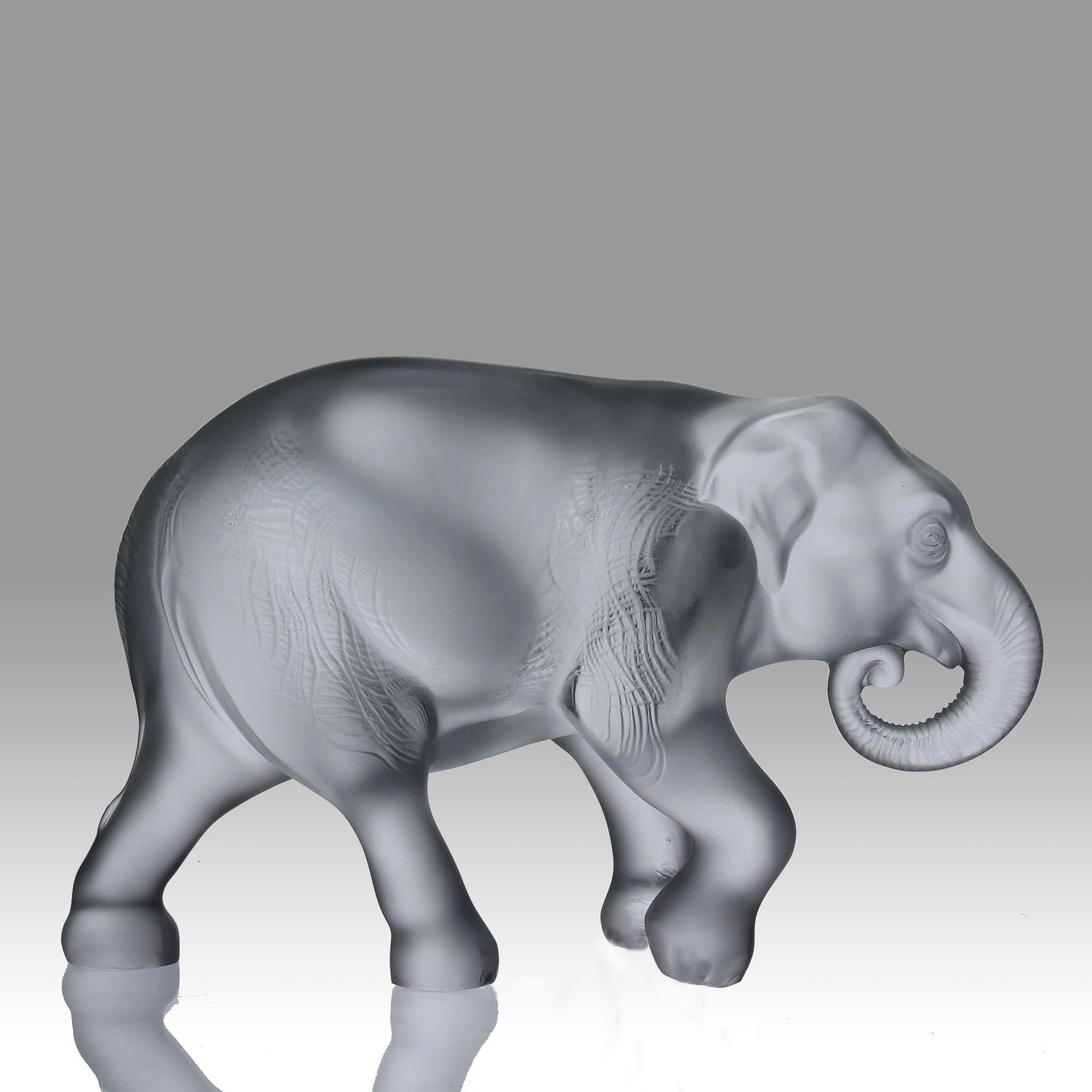 An impressive frosted and clear glass study of a walking Javanese elephant with textured surface and fine hand finished detail, signed Lalique France

ADDITIONAL INFORMATION

Height:                                       17 cm

Width:               