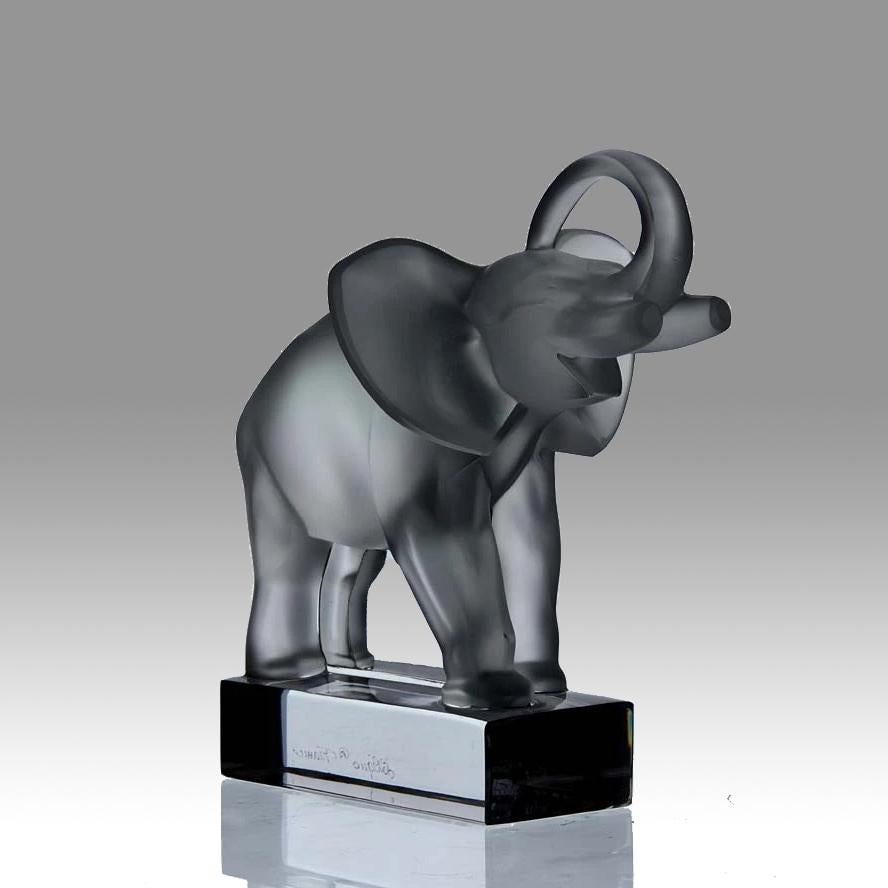 Impressive Mid-20th Century clear and frosted glass figural study of an African elephant with its trunk raised. The surface with fine detail, signed Lalique France

Additional information
Height: 15 cm

Condition: Excellent Condition

circa:
