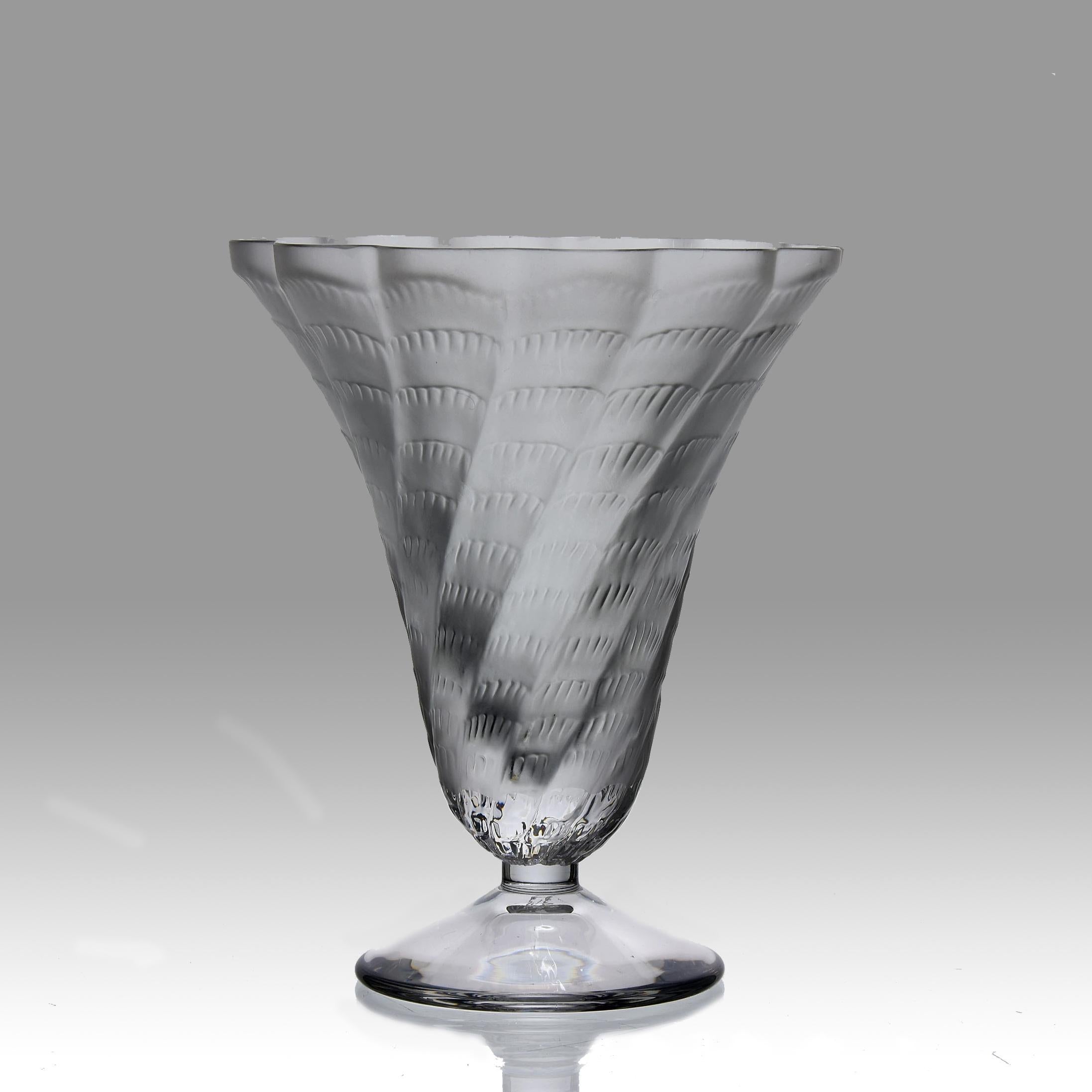 An attractive clear and frosted glass vase decorated with a tornado effect complete with scalloped edge rim. Exhibiting very fine hand finished detail, signed Lalique France

ADDITIONAL INFORMATION

Height: 15 cm

Condition: Excellent