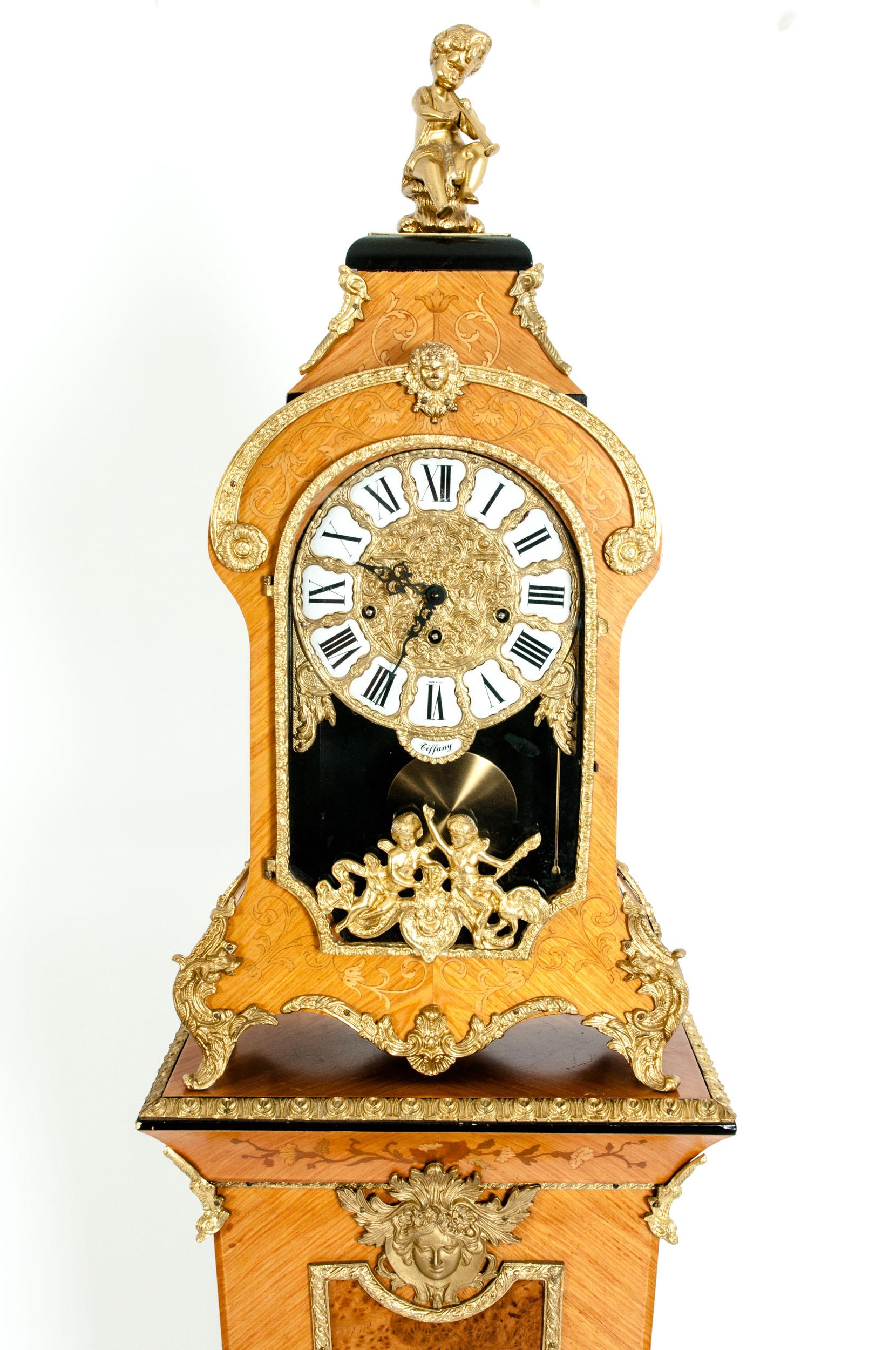 20th century fruitwood veneer case with inlaid floral motif details with bronze mounted design Tiffany mantel clock with pedestal. The clock was created in Italy with German movements. The clock is in excellent condition with appropriate wear