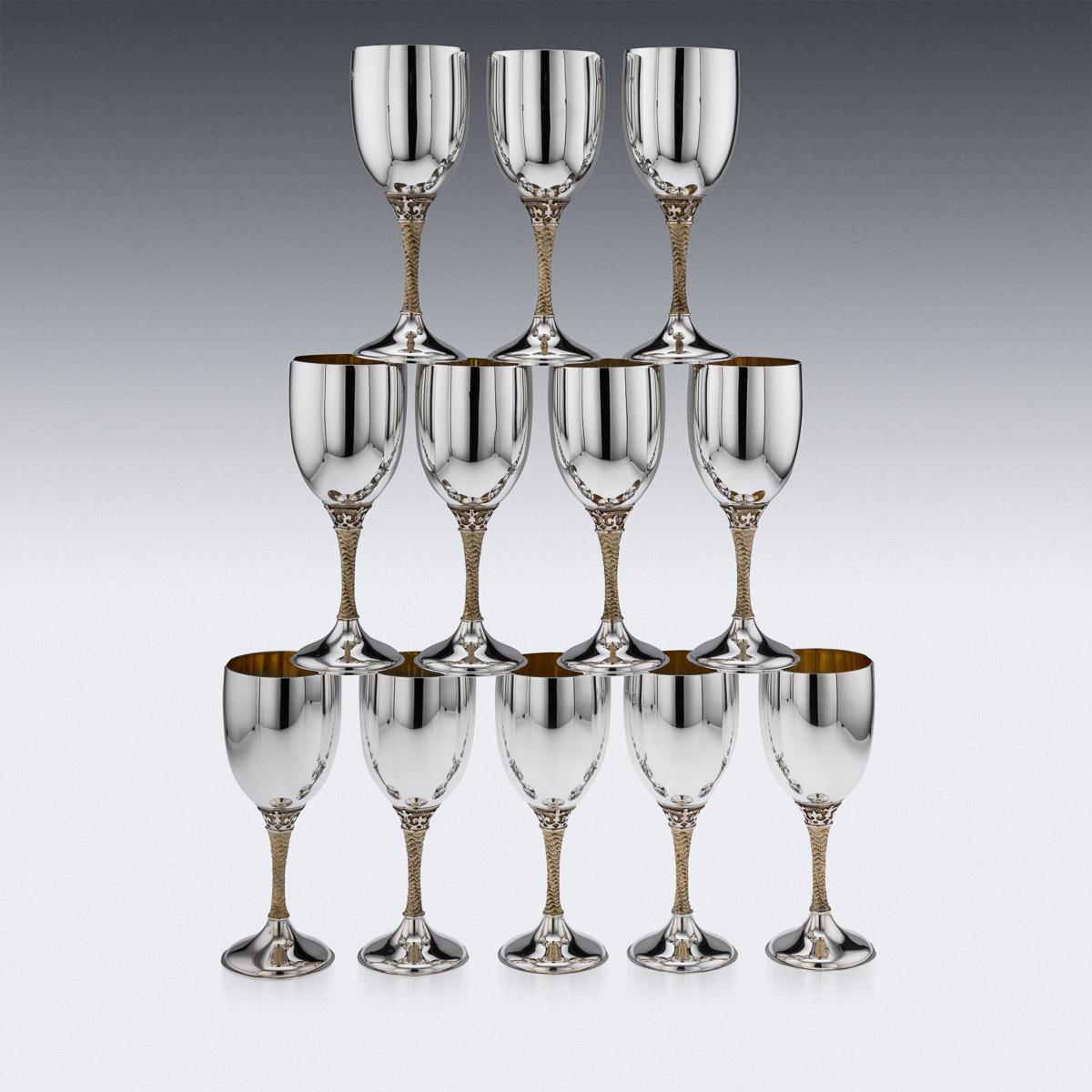 20th Century English silver set of 12 wine goblets, magnificent size and weight, in traditional form, the stems cast with very unusual wavy and textured decoration and richly gilt, the tops of the stems decorated with protruding Fleur-de-lis,