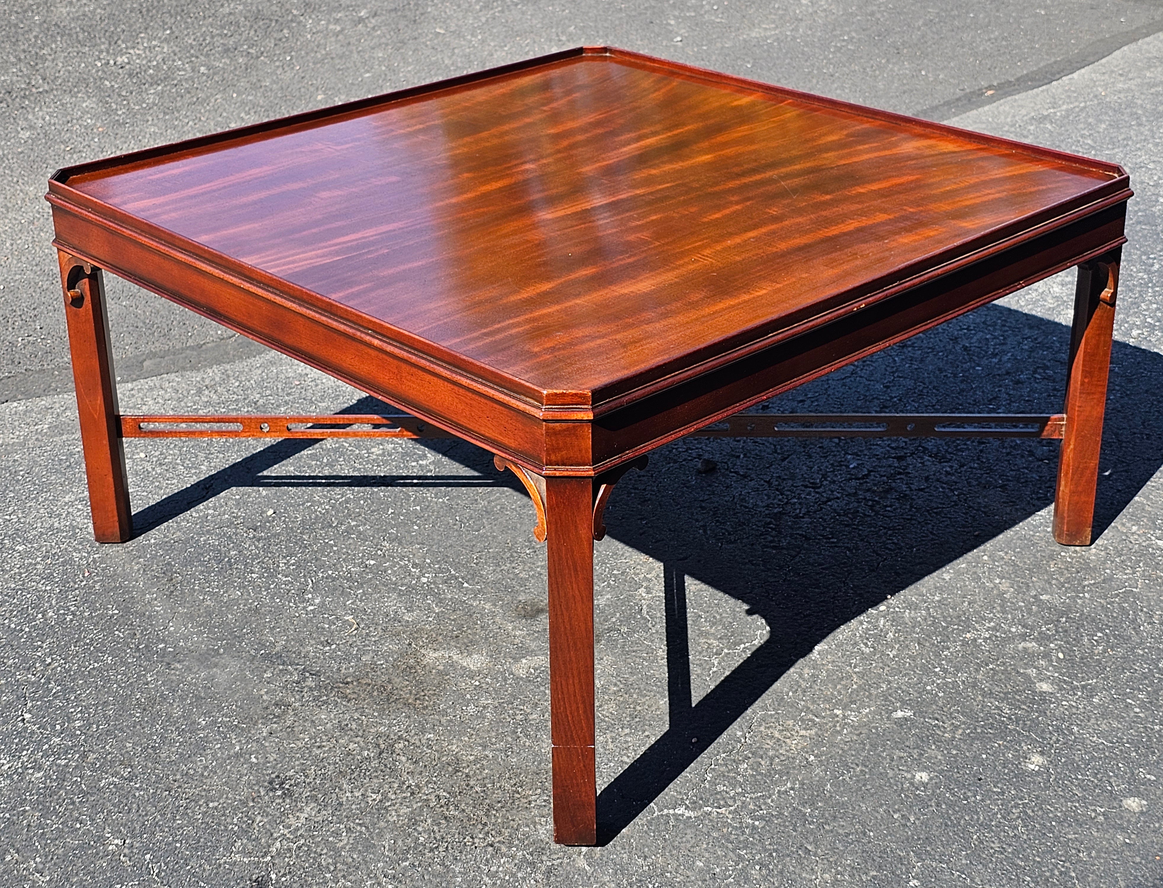 A 20th Century George III Style Solid Mahogany Square Coffee Table with pierced Stretcher. Measures 37
