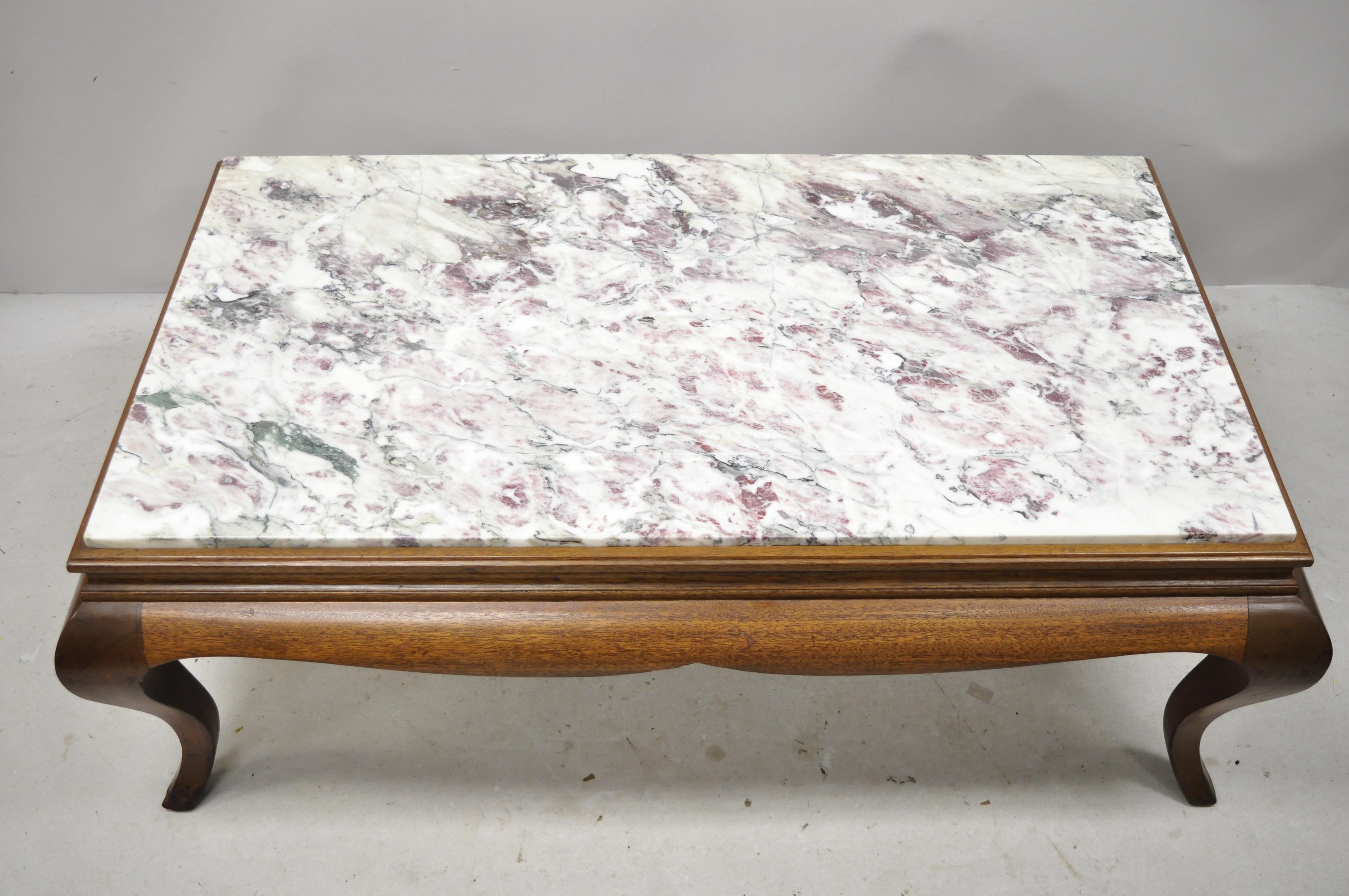 Early 20th century Georgian Hollywood Regency mahogany frame marble top coffee table. Item features a stunning marble top with pink and purple veins, solid wood frame, beautiful wood grain, shapely cabriole legs, quality american craftsmanship,