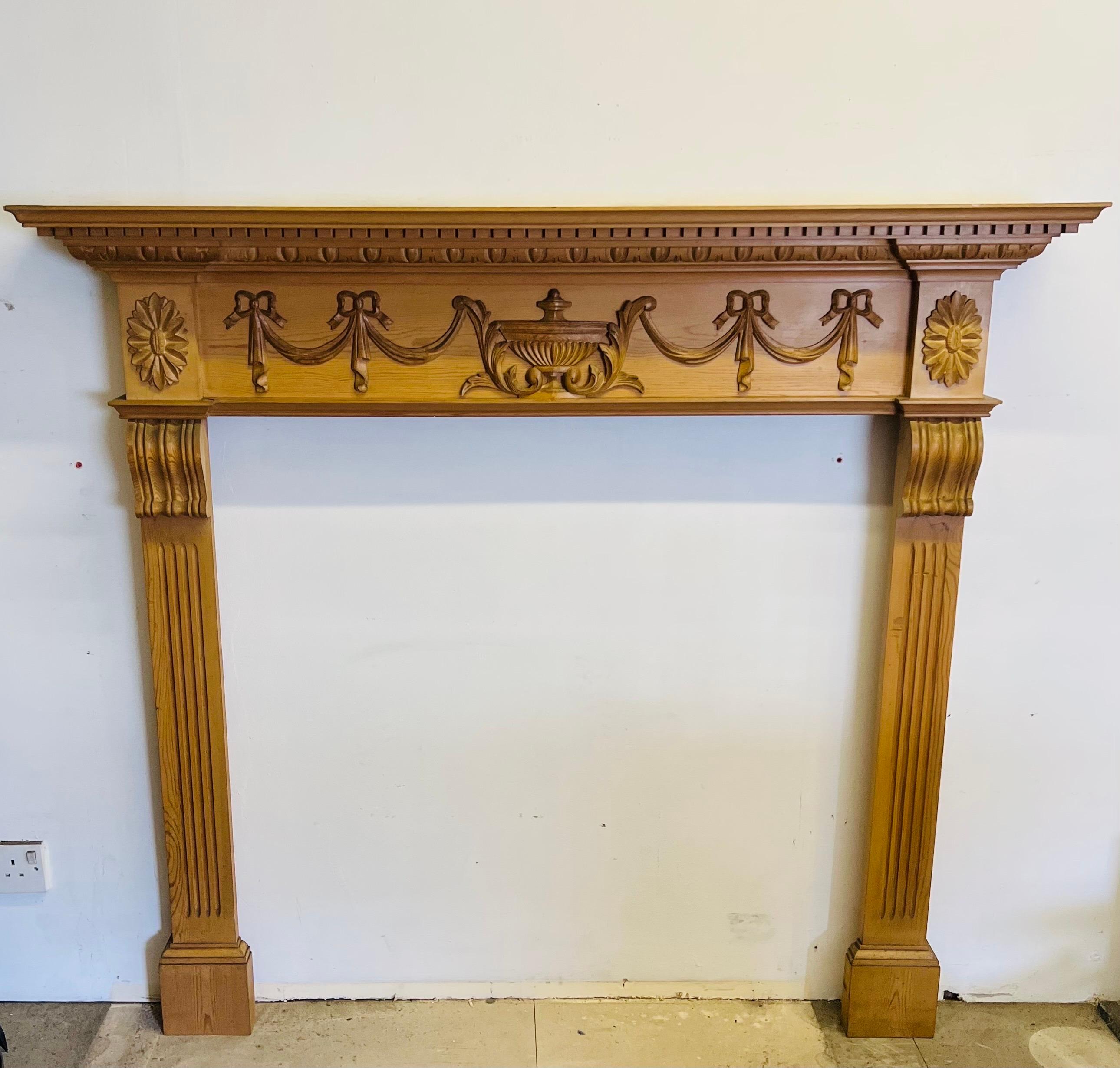 Our Georgian style, hand-carved mantelpieces and pine fire surround
A delightful design with a carved floral centre and fluted frieze.


Dimensions:

Shelf Width 55. 1/8 inch
Shelf Depth 7. 3/4 inch
Overall Height 50. 1/4 inch 
Opening