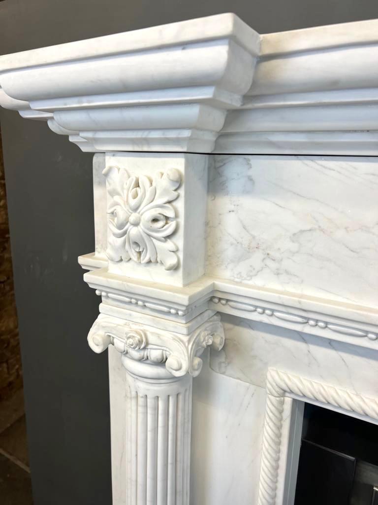 20th Century Georgian Style White Marble Fireplace Mantlepiece.
This Statuary Marble Pillar Fireplace Surround Is Hand Carved In Traditional Georgian Style,
With Pillars, Capitals, Swags & A Double Break Fronted Shelf.  
This Is On Offer Together