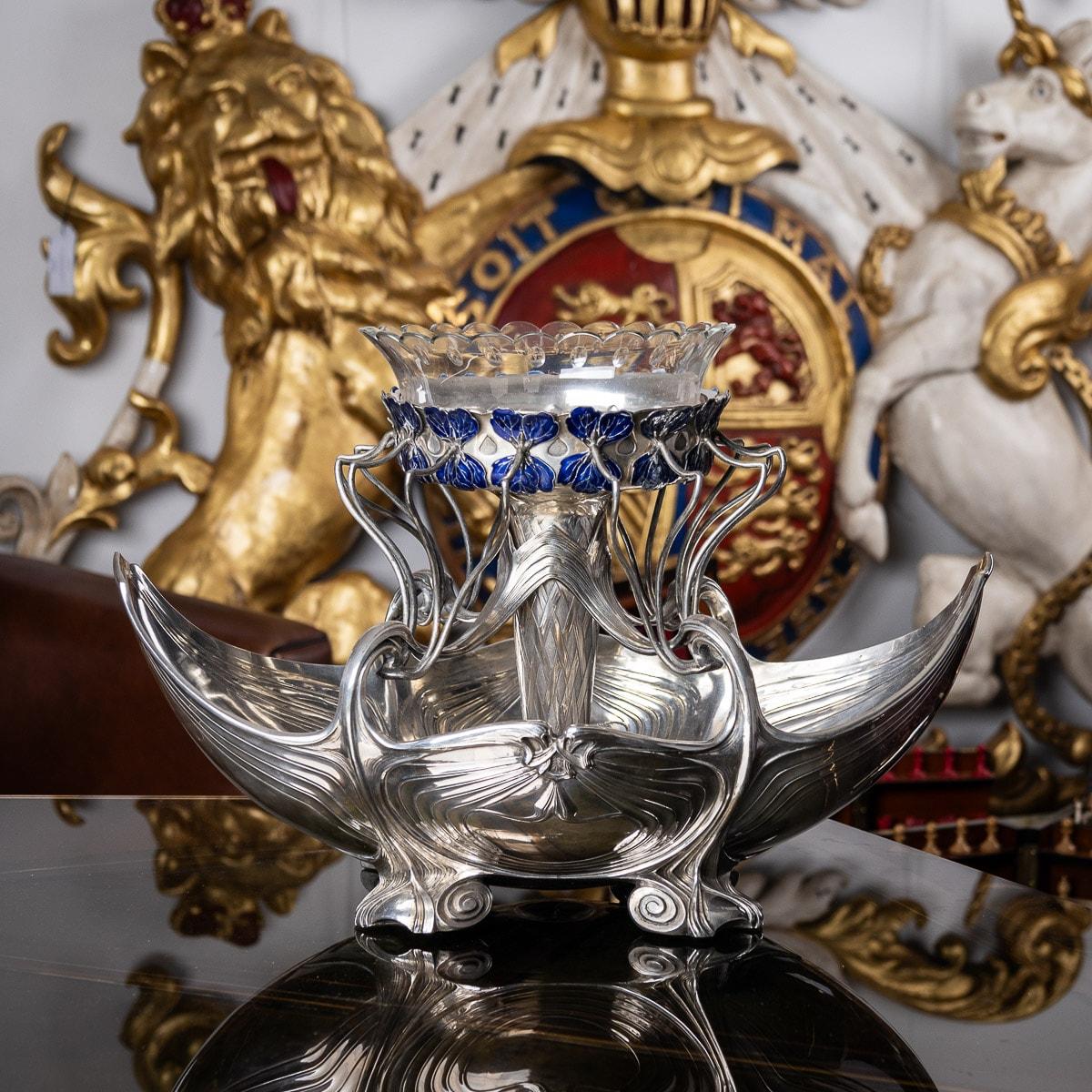 Antique early-20th Century German Art Neuveau Impressively large solid silver and enamel centrepiece. The bowl raised on four spreading scroll feet, decorated throughout with flowing floral motifs and applied with unusual flowing handles suspending