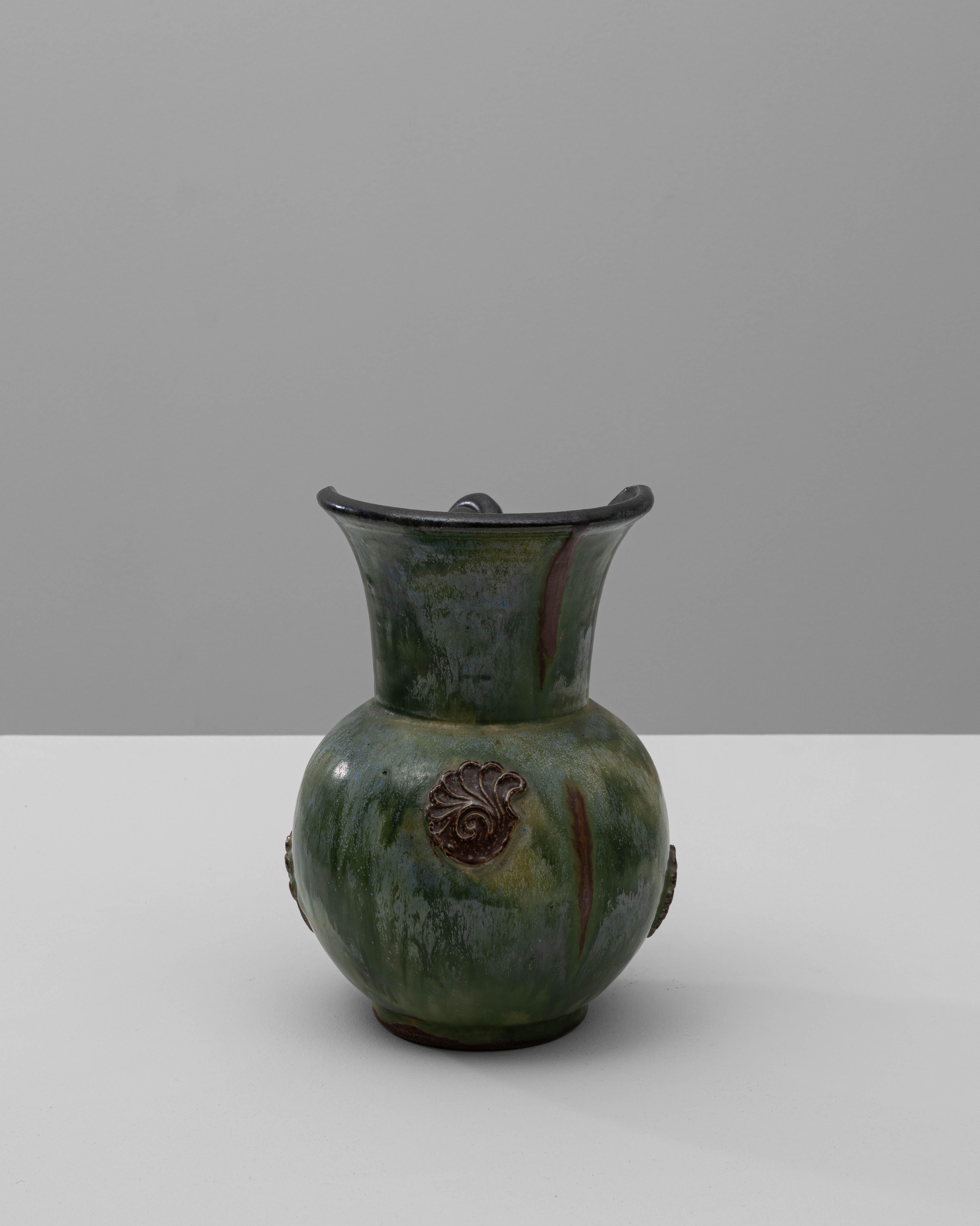 Questa affascinante brocca in ceramica tedesca del XX secolo è un ottimo esempio di arte funzionale con la sua accattivante miscela di forma e design. Caratterizzata da un esclusivo manico attorcigliato in uno smalto nero intenso, questa brocca