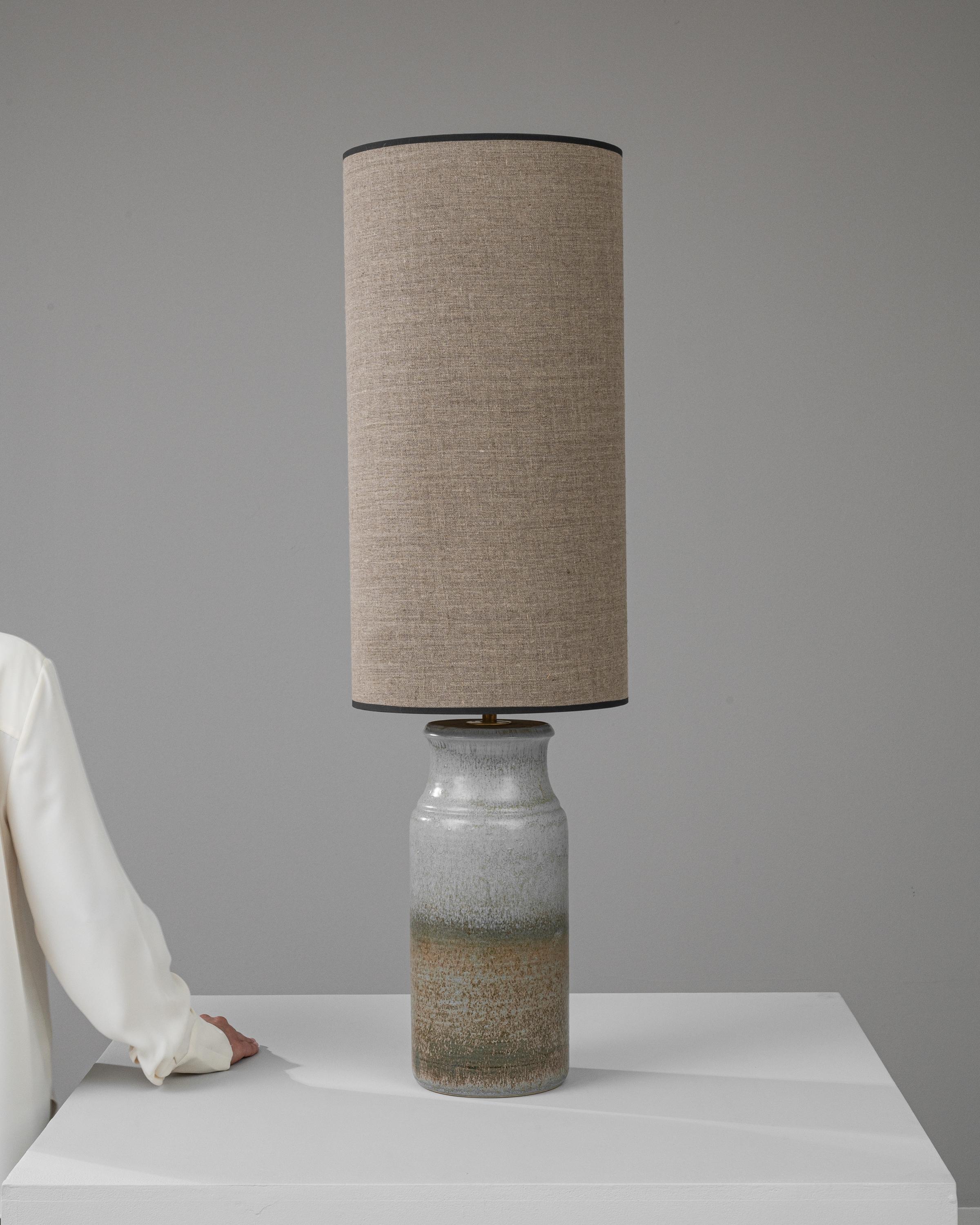 Introducing the 20th Century German Ceramic Table Lamp: an embodiment of rustic charm and minimalist elegance. This lamp showcases a stunning ceramic base with a gradient of earthy tones, layered to create a serene visual effect reminiscent of
