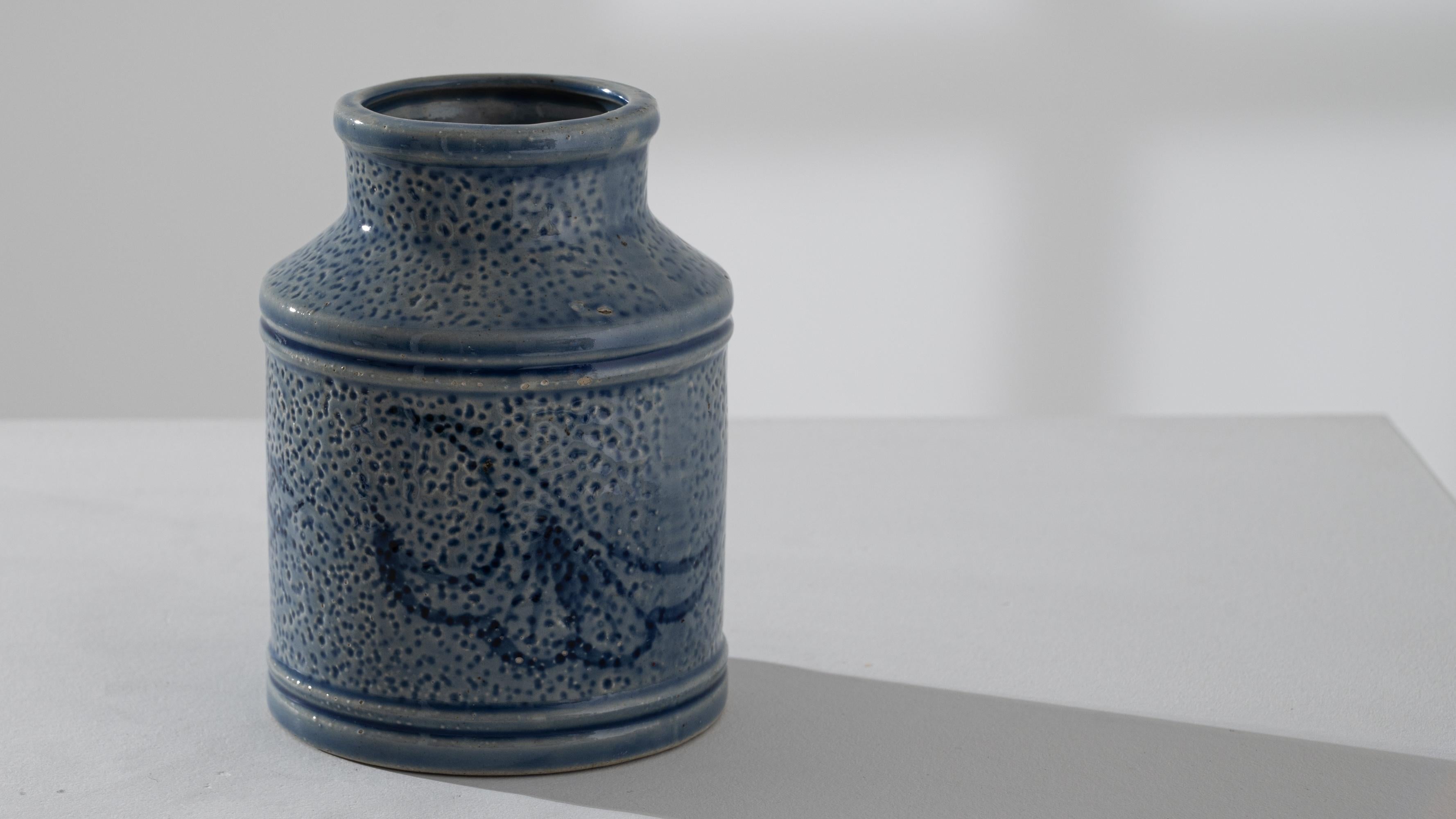 Elevate your décor with this 20th Century German Ceramic Vase, a testament to artistic craftsmanship. Adorned with intricate blue designs and a delicate stipple pattern, this vase stands out as a masterpiece of German ceramic artistry. The central