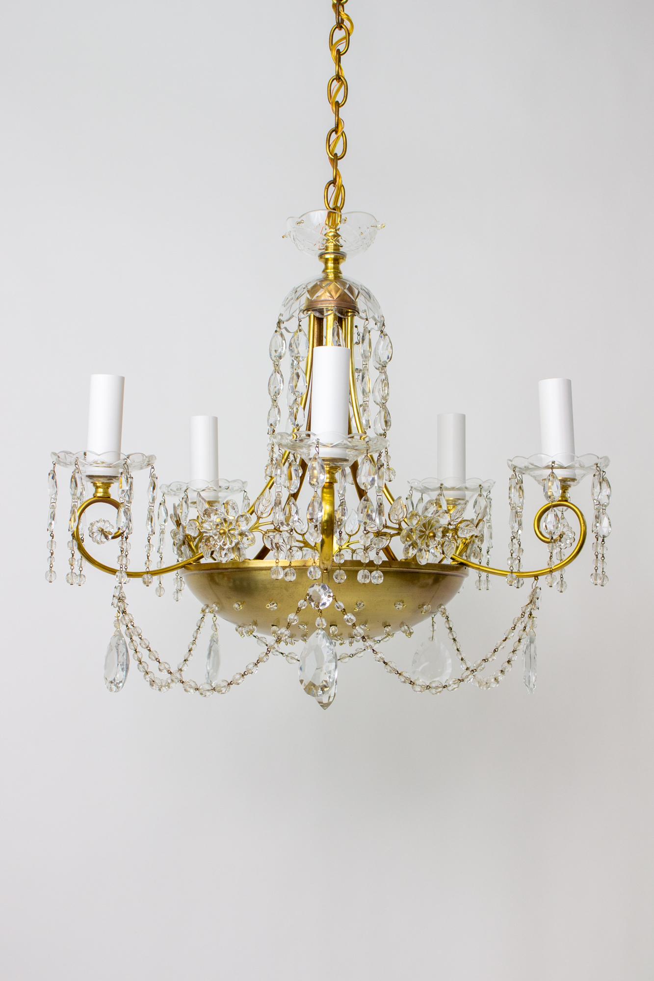 Introducing our exquisite 20th Century German Brass and Crystal Chandelier, a timeless piece that combines craftsmanship, elegance, and vintage allure. This stunning chandelier, reminiscent of the Maison Bagues style, showcases meticulous attention