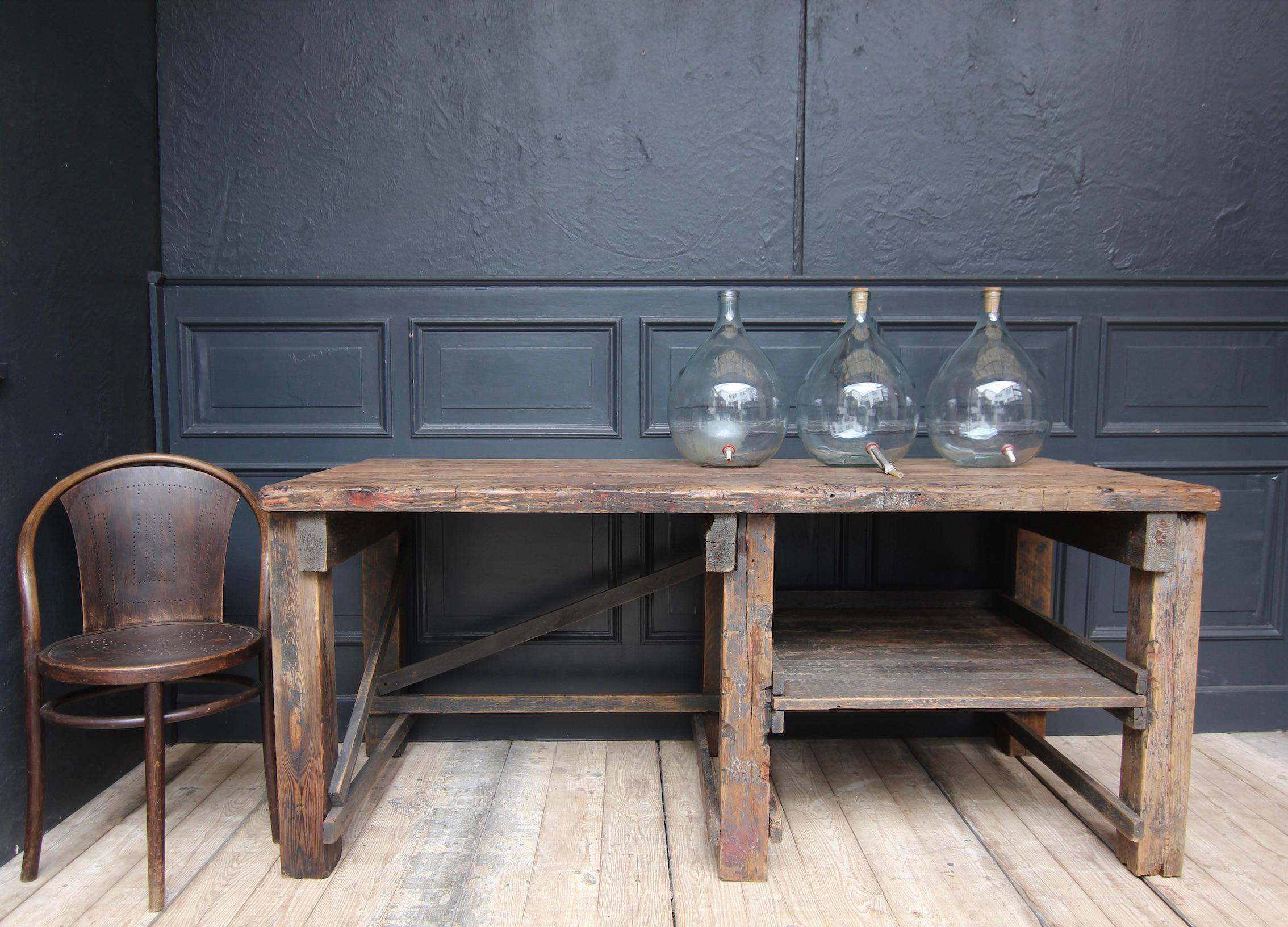 Industrial vintage work table made of pine wood with a beautiful original patina. Slightly restored ready for everyday use (including completely sanded and sealed transparently).

Standing on 6 square legs, with a storage compartment in the frame